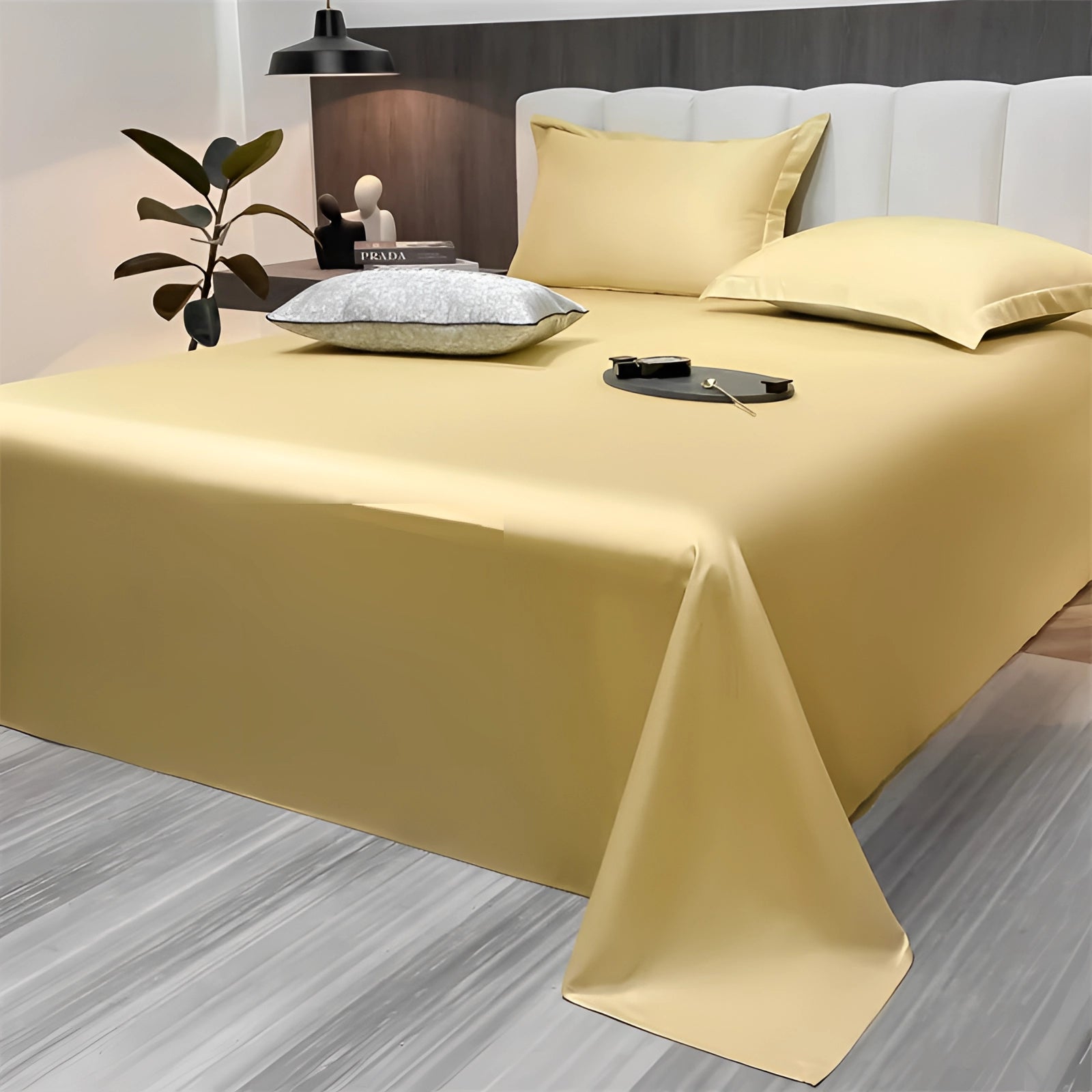 A luxurious sea green silky bed sheet set in a modern minimalist bedroom, featuring a yellow accent. The room is elegantly designed with a wooden floor and minimalist furniture, complementing the serene ambiance and stylish decor.