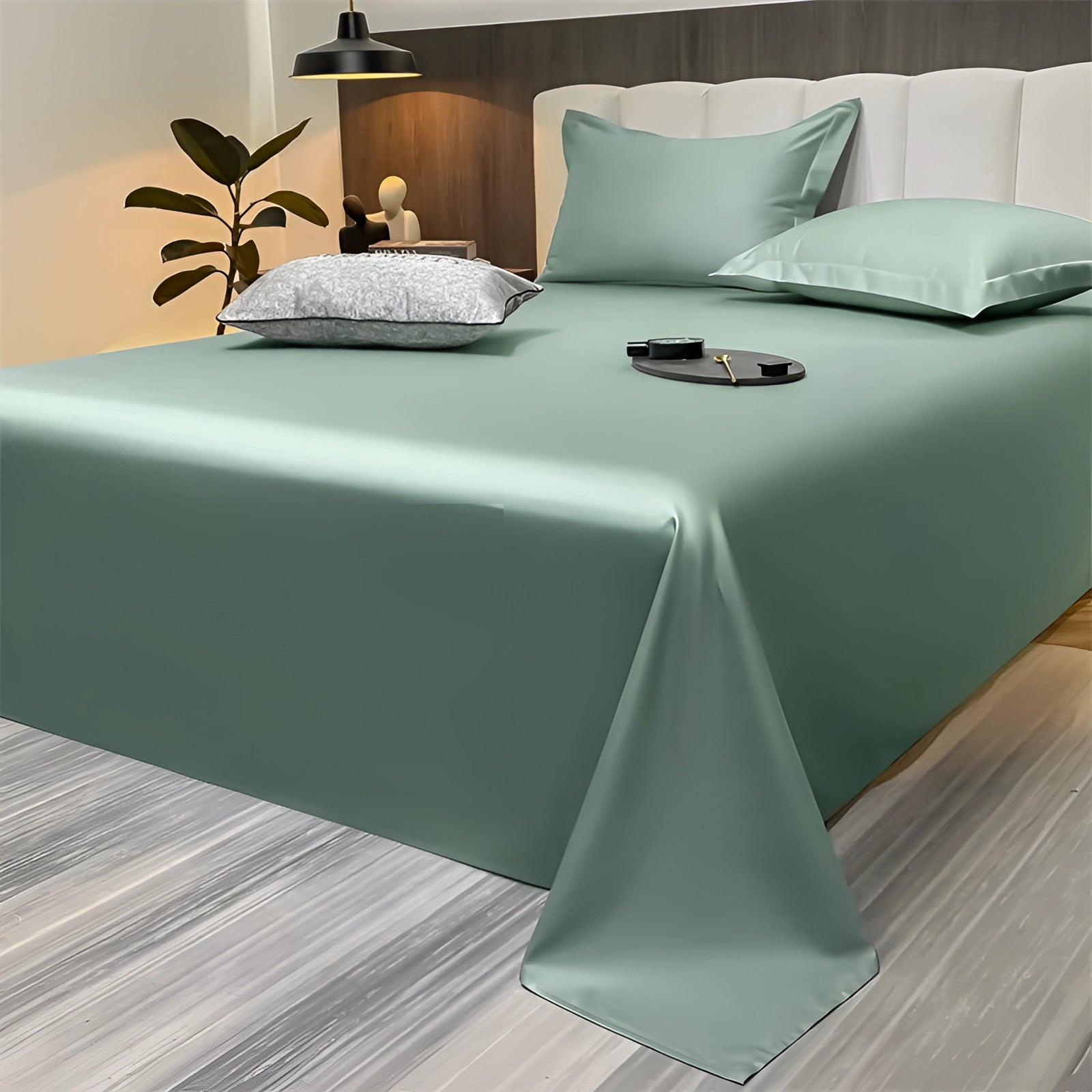 Sea green silky luxury bed sheets in a modern minimalist bedroom setting, featuring a spacious 245x265cm size, displayed on a neatly made bed with white and wood accents in the decor.
