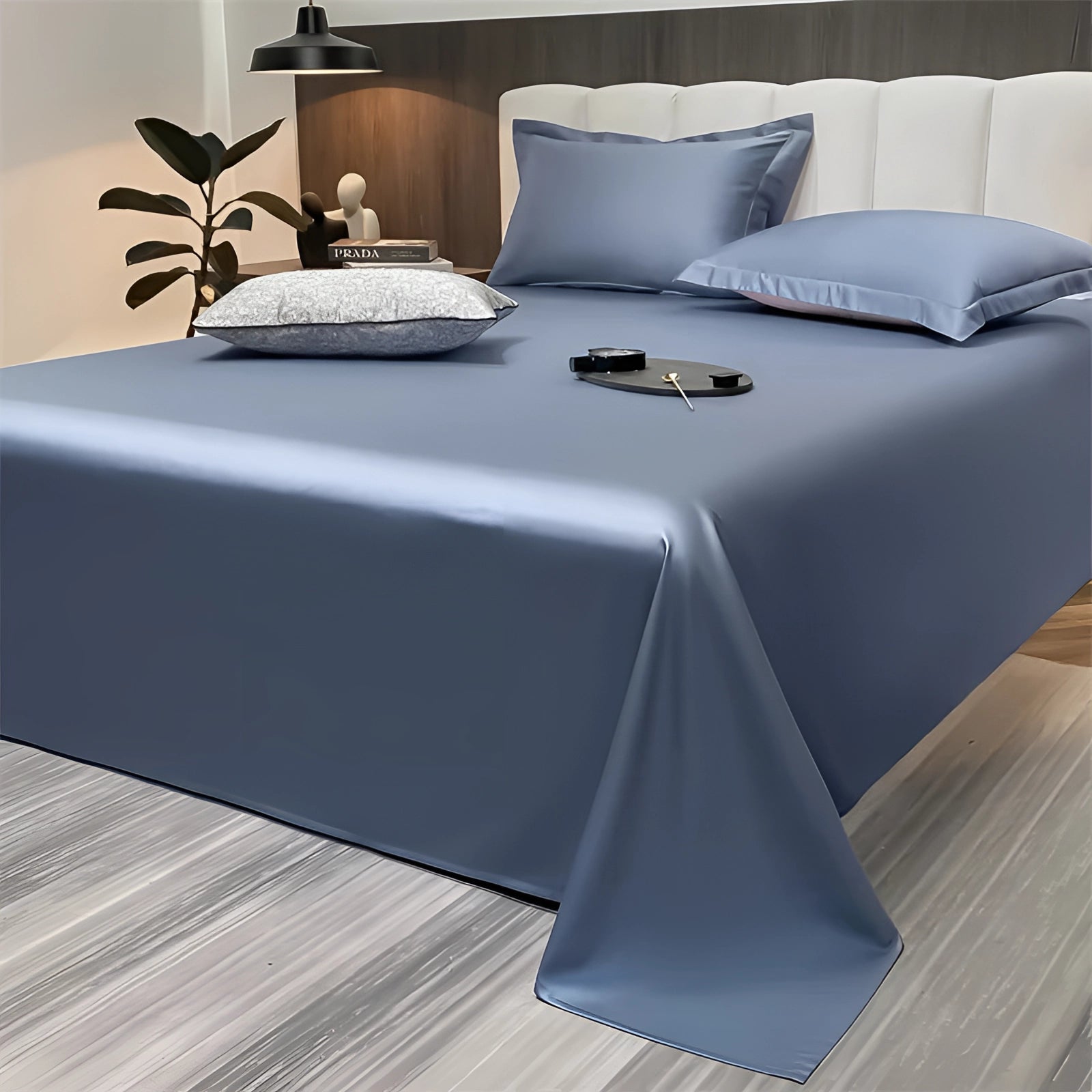 Sea green silky luxury bed sheets draped elegantly over a bed, showcasing a modern minimalist decor style with a hint of blue. The sheets create a comfortable and inviting atmosphere in the bedroom, complemented by a sleek interior design.