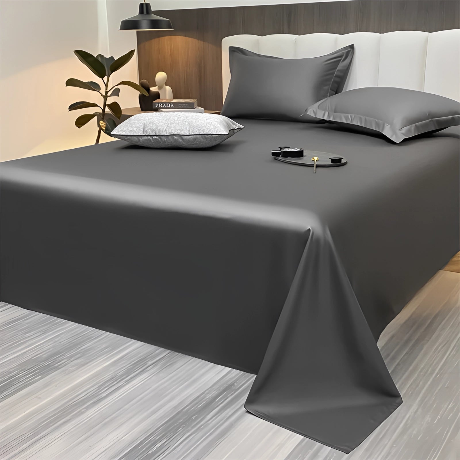 Luxurious, silky sea green bed sheets in a modern minimalist bedroom setting, featuring a dark gray color variant measuring 245x265cm, displayed on a neatly made bed with a minimalist decor theme.