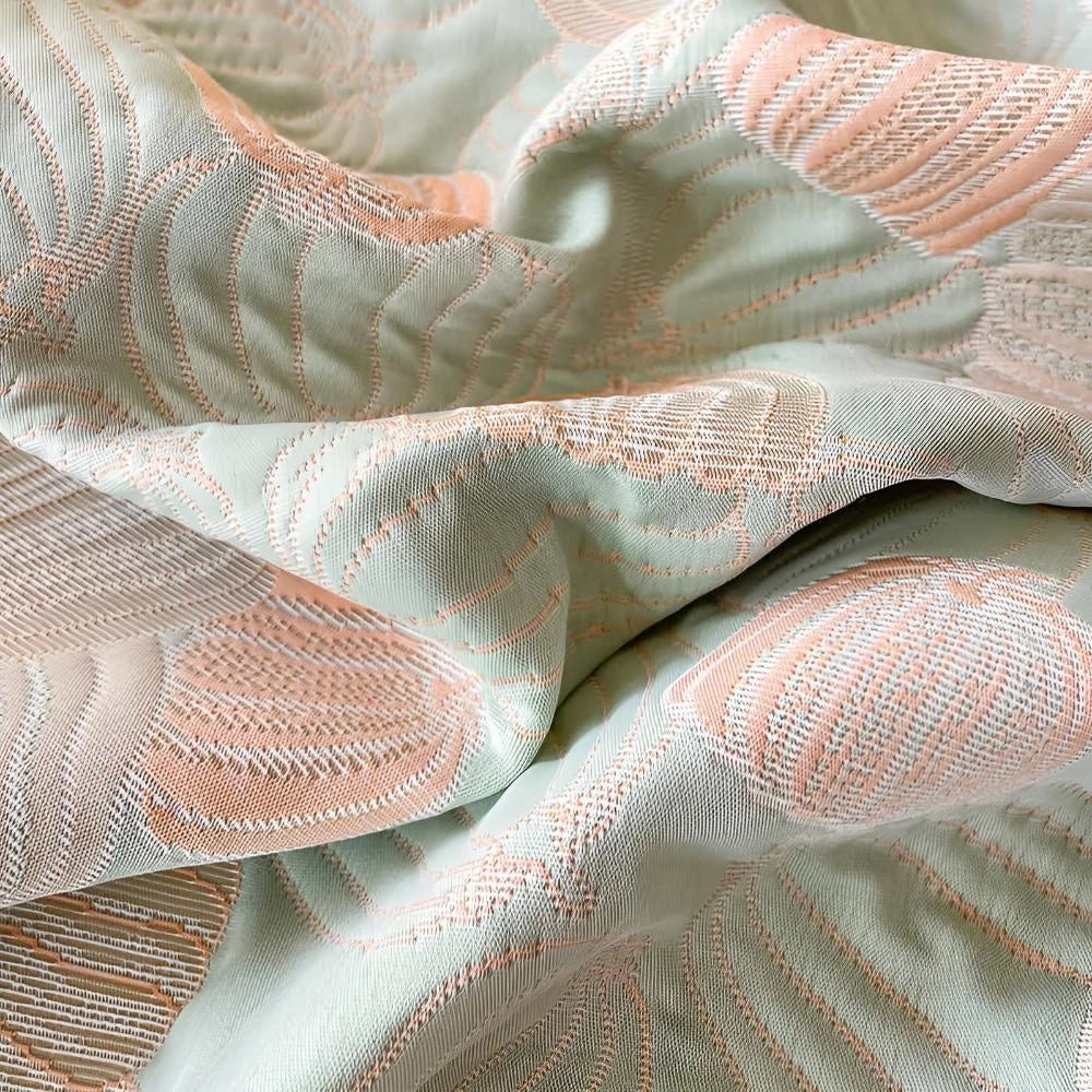 Pastel beach-themed duvet cover with seashell and ocean-inspired patterns, featuring soft peach and grey tones, displayed in close-up detail.