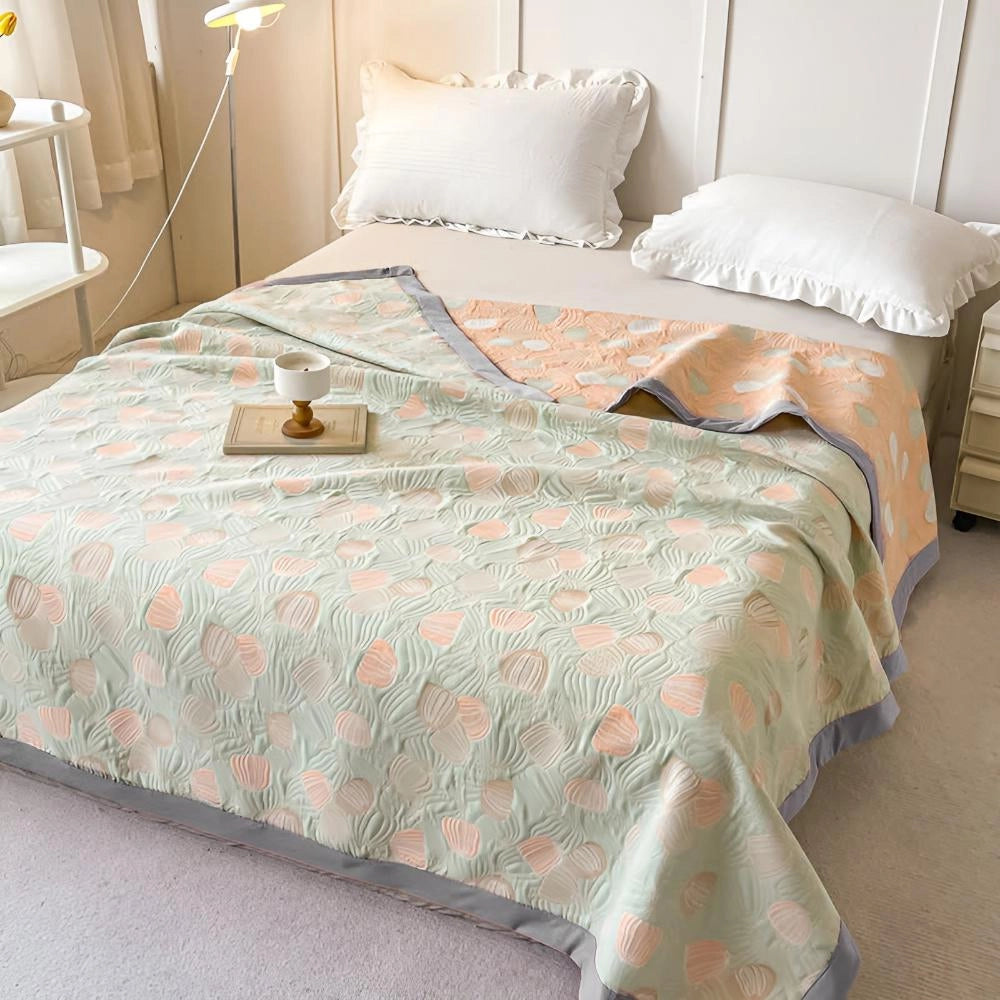 Ocean-inspired duvet cover with a pastel beach theme on a bed in a cozy bedroom setting, featuring white and wood accents and a comfortable, inviting atmosphere.