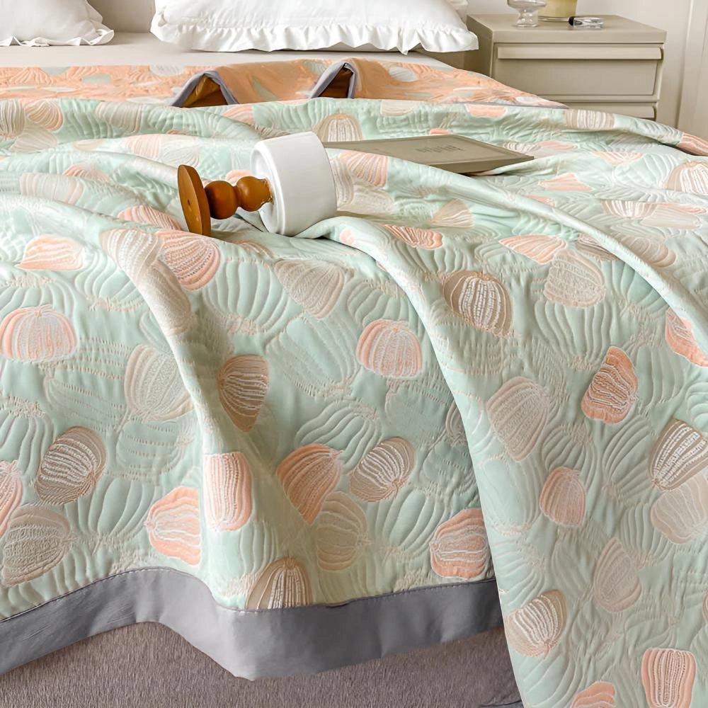 Pastel beach-themed duvet cover with ocean-inspired seashell patterns on a neatly arranged bed, surrounded by azure and aqua tones, emphasizing comfort and relaxation in a stylish bedroom setup.