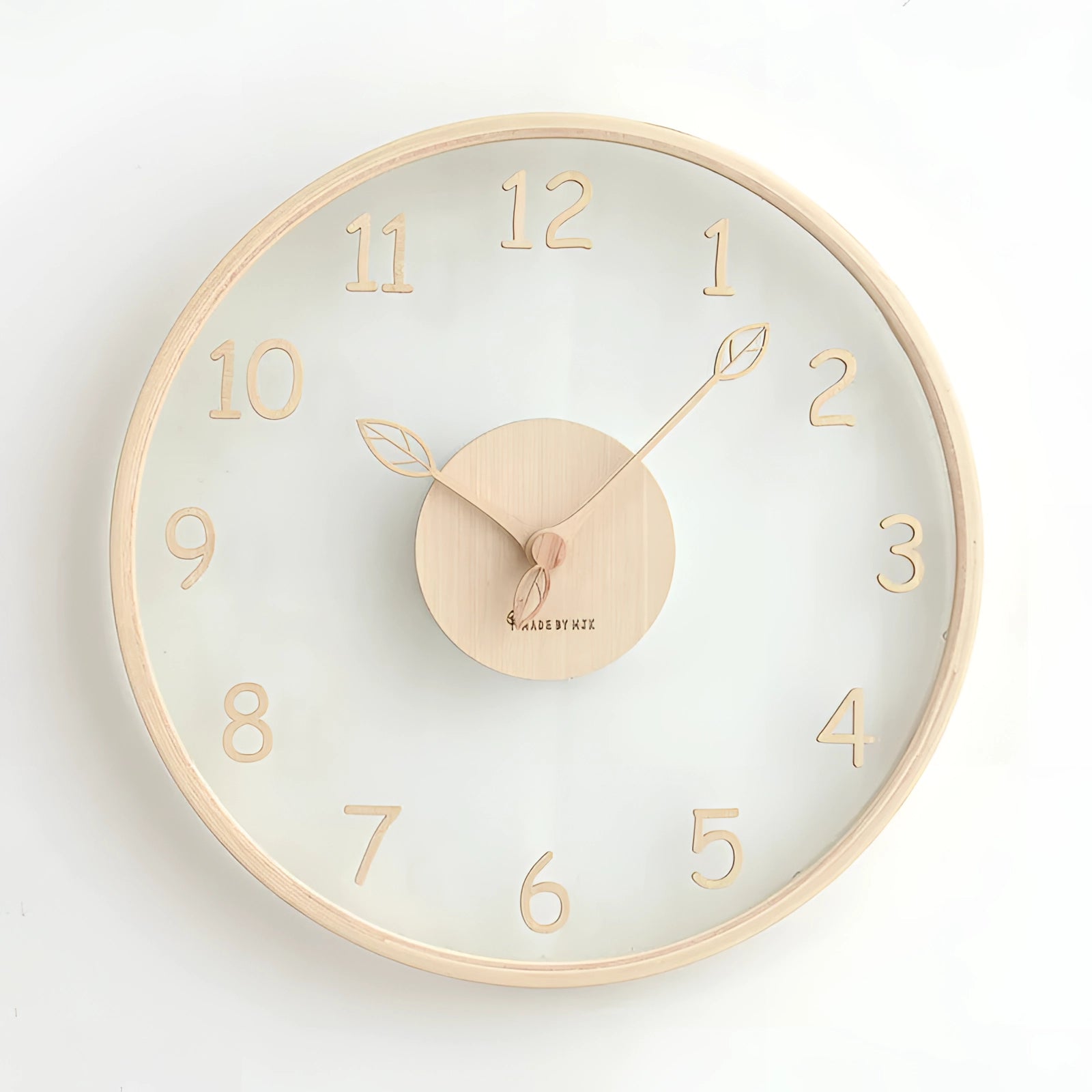 Minimalist silent Scandinavian light wood wall clock with a circular design, featuring peach-colored numerals and a simple, elegant font, suitable for interior design.