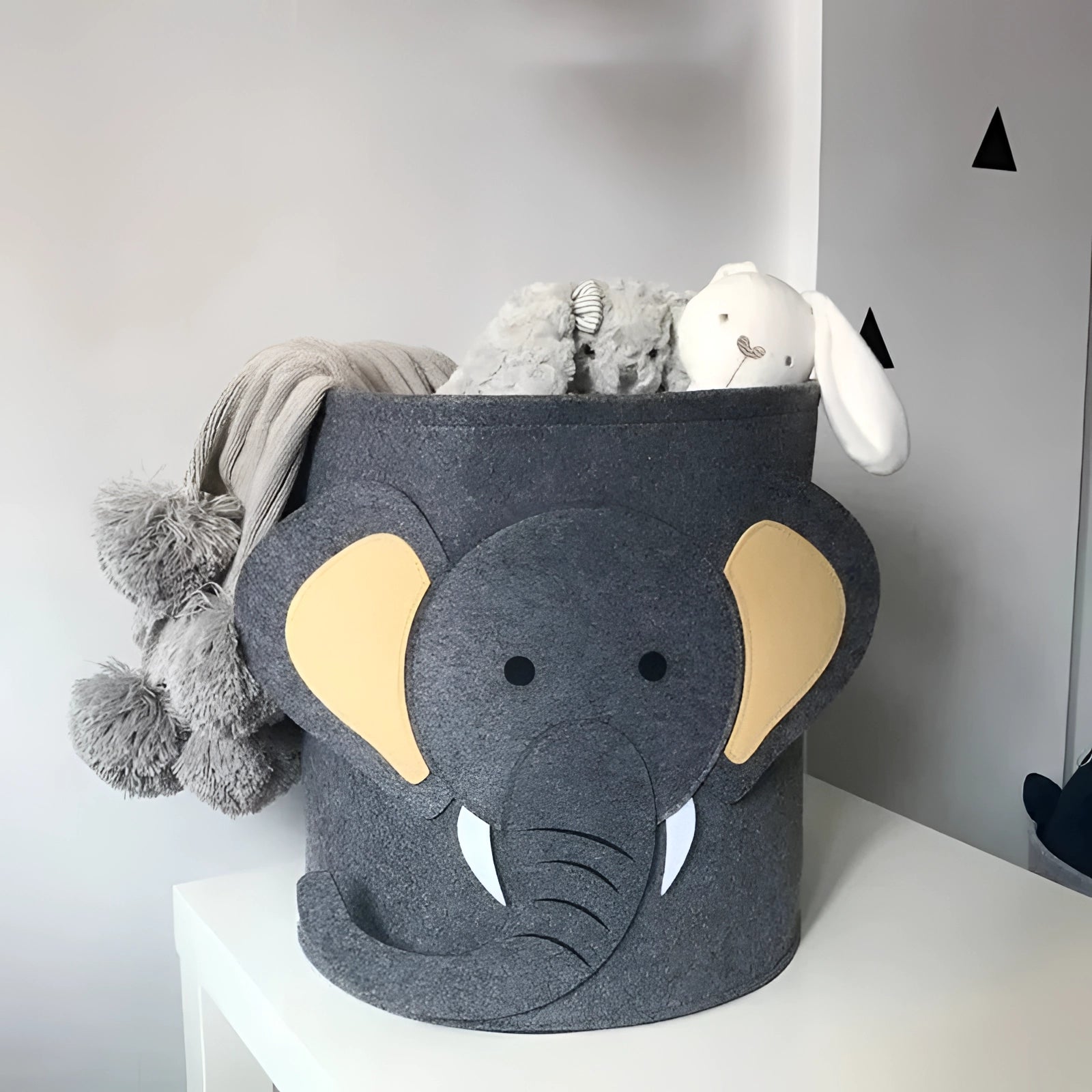 Gray shark-themed felt basket for kids' toy storage, resembling a plush stuffed toy, suitable for organizing nursery items.