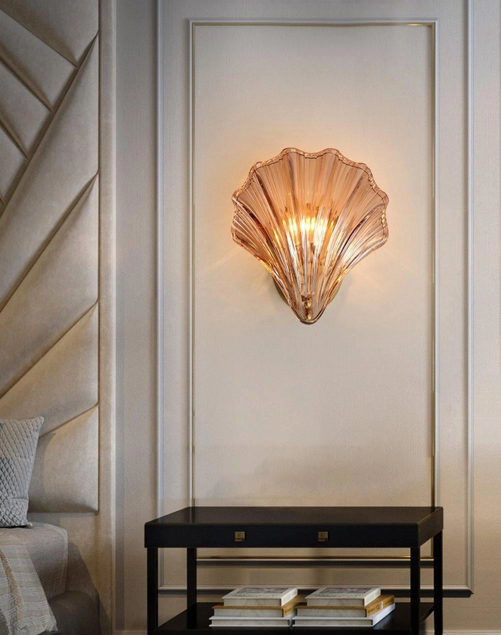 Gold Shell Wall Sconce in a coastal nautical design mounted on a wooden wall in an interior setting.