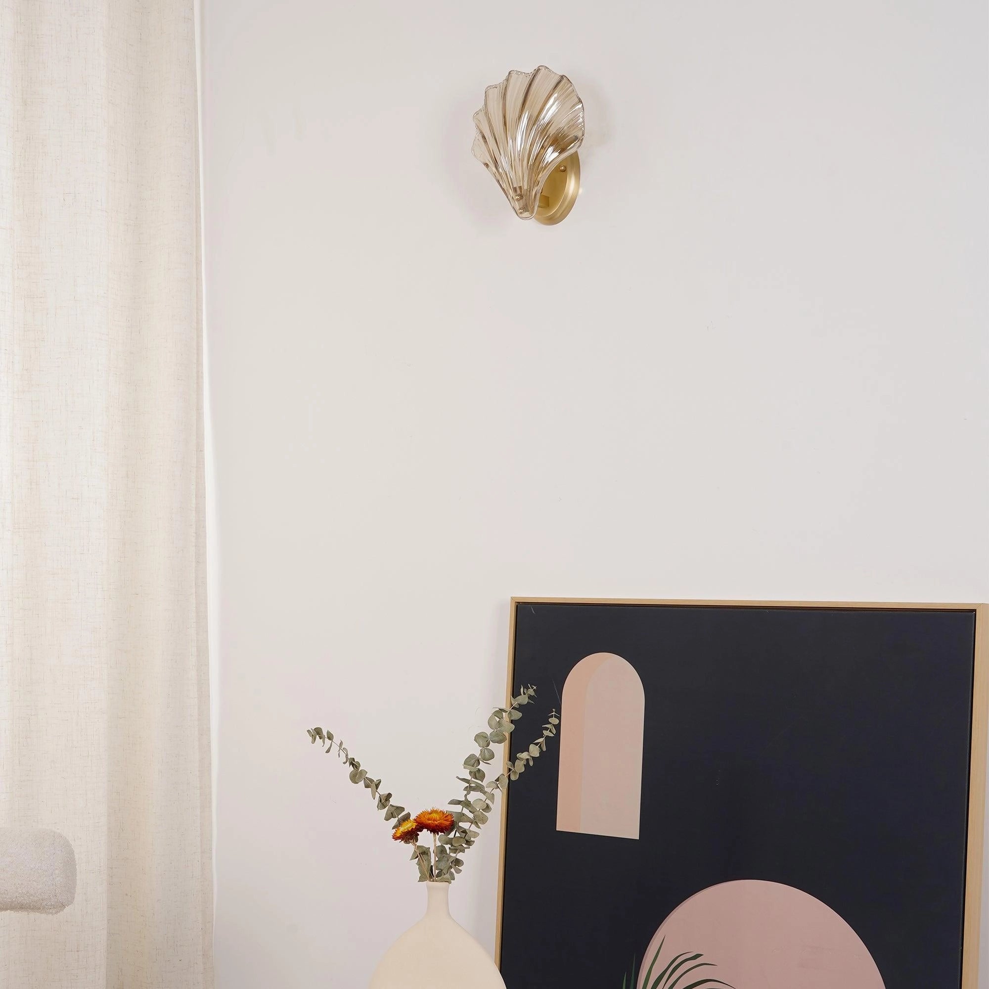 Gold Shell Wall Sconce with Nautical Coastal Seashell Design Mounted on Wooden Wall Decor.