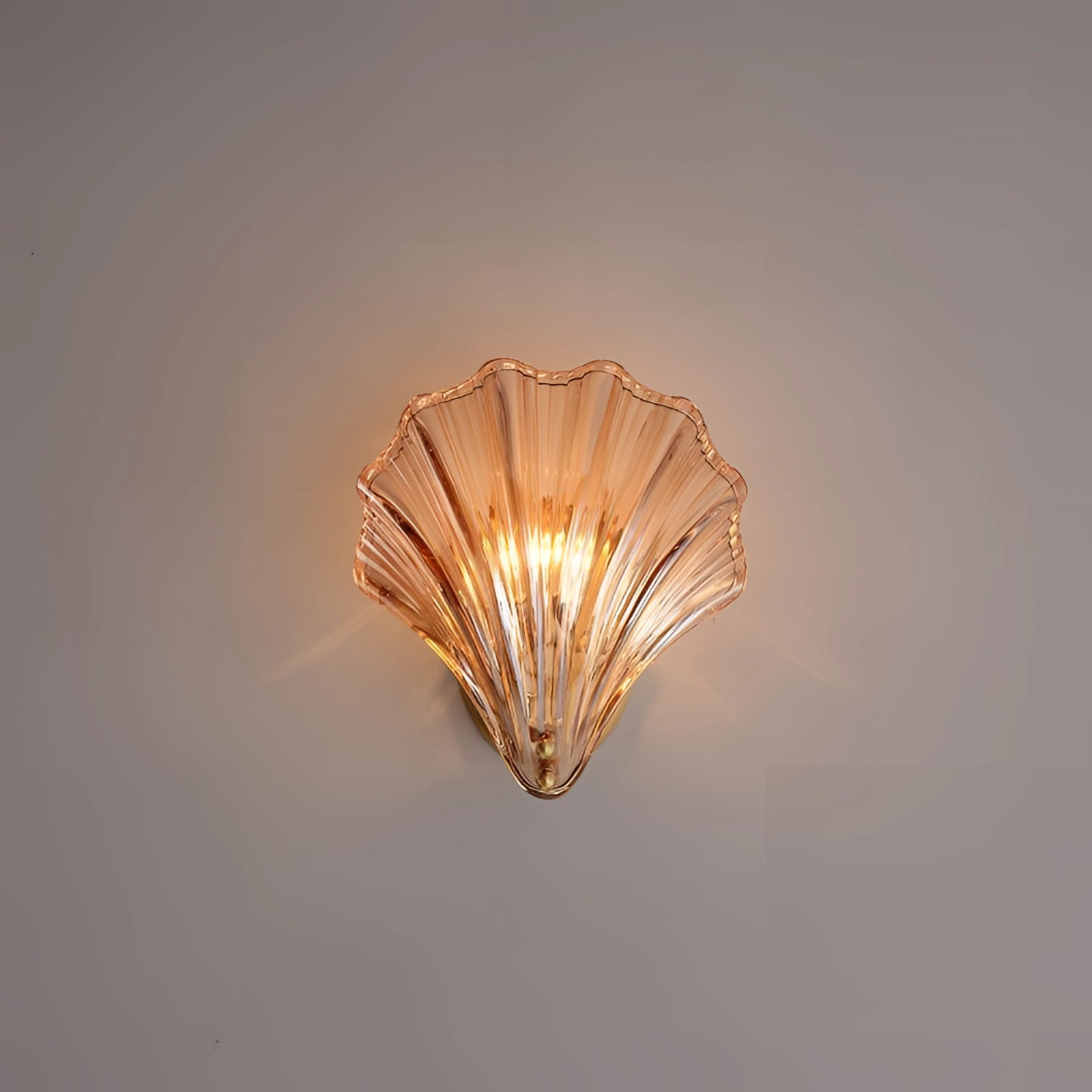 Gold nautical coastal seashell wall sconce light fixture with intricate shell design, mounted on a wall.