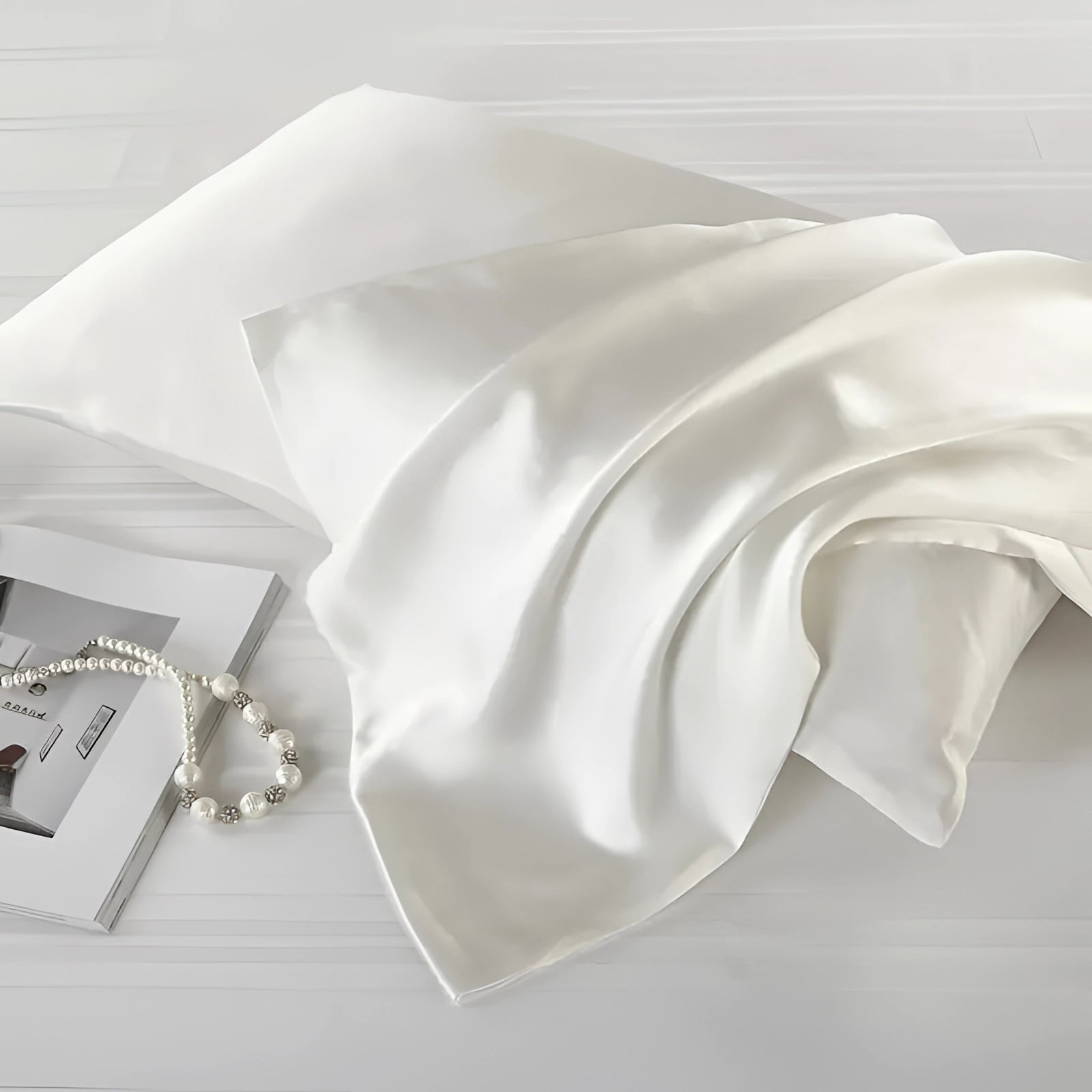 Ivory white silk slip dress displayed elegantly, showcasing its luxurious satin texture, suitable for evening wear or chic loungewear.