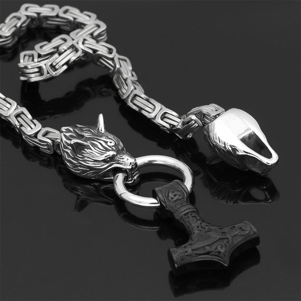 Silver Viking wolf head and Mjolnir pendant featuring intricate Norse designs in a monochrome metallic finish, exemplifying traditional men's jewelry and fashion accessories.