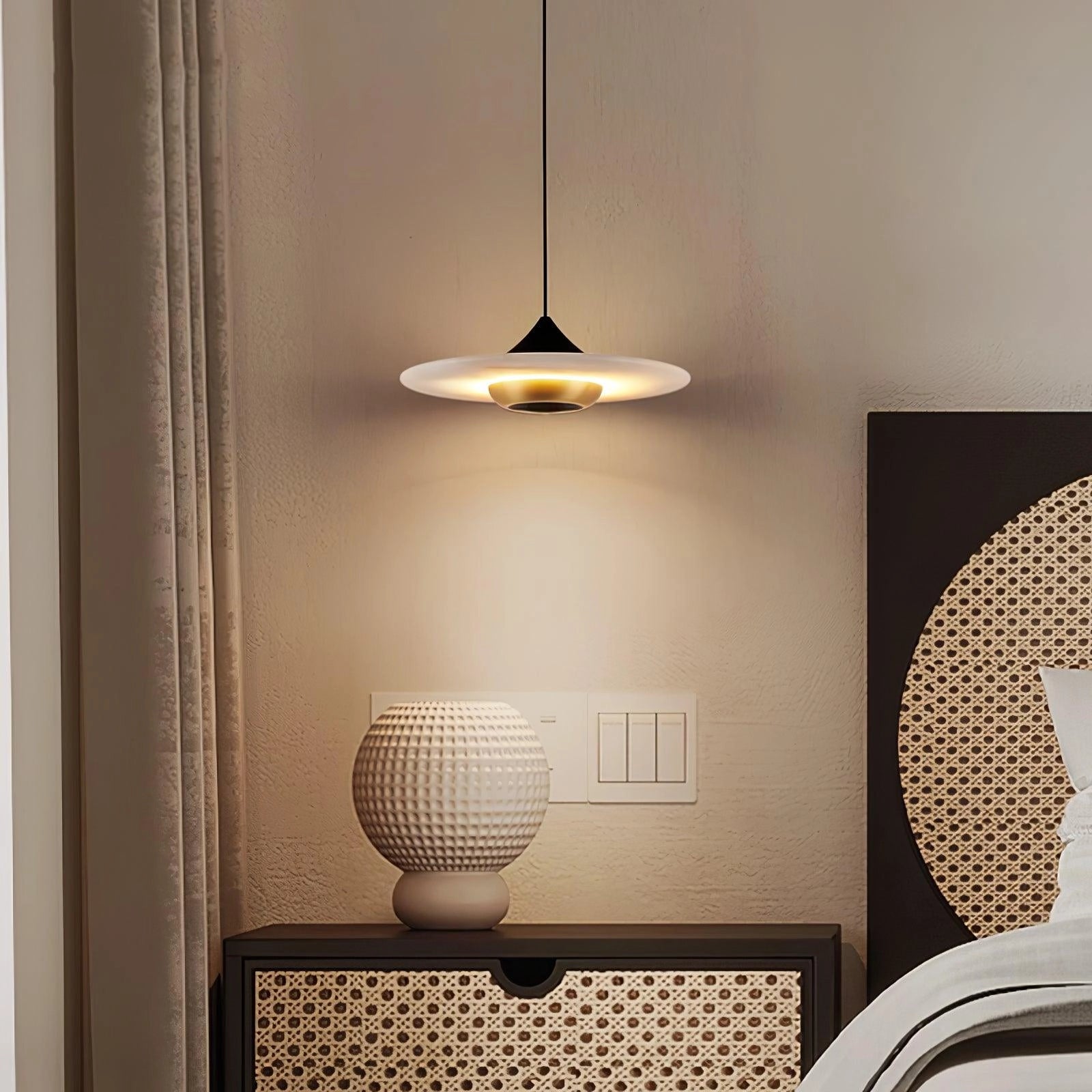 Sleek black LED pendant light with a modern minimalist design, featuring a smooth wooden shade, illuminating an interior space.