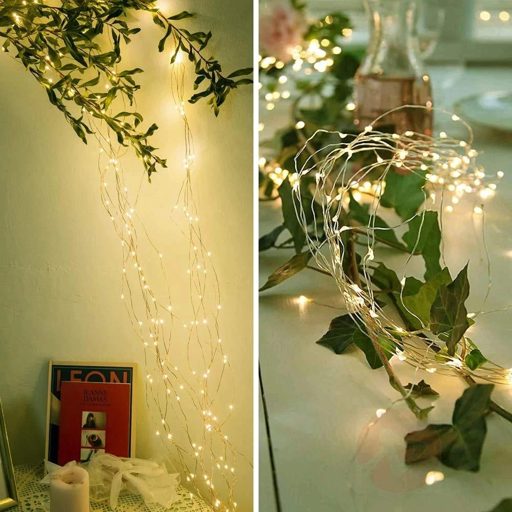 Solar powered outdoor LED fairy lights draped elegantly over green twigs and branches, creating a festive and eco-friendly decoration with a warm yellow glow, ideal for enhancing outdoor spaces with a touch of whimsy and sustainability.