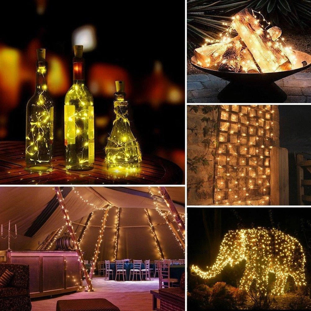 Solar powered outdoor LED fairy lights hanging inside glass bottles, emitting a warm golden glow, set against a dark background. The lights create an enchanting and eco-friendly illumination perfect for outdoor events or garden decoration.