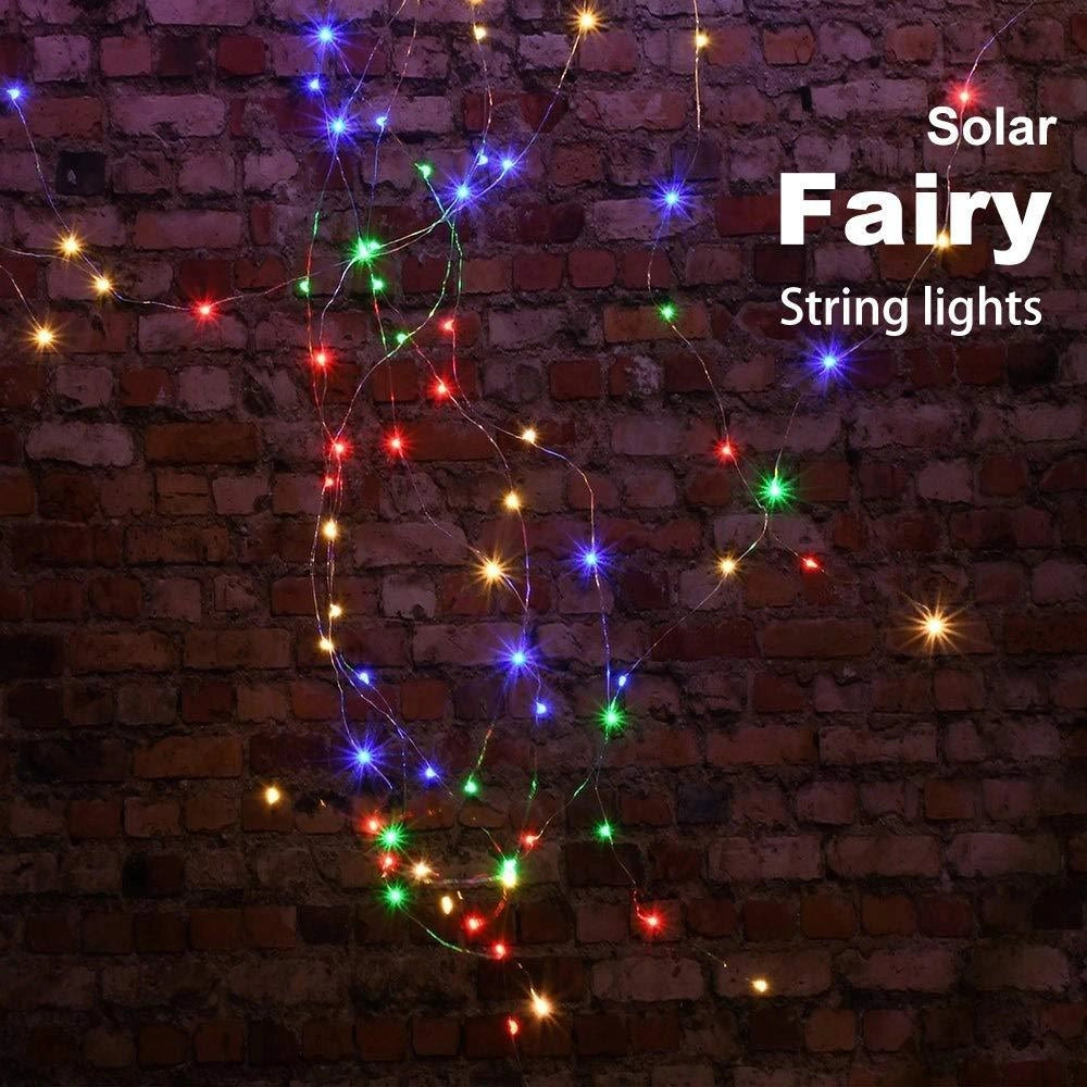 Solar powered outdoor LED fairy lights strung among tree branches, creating a sparkling visual effect against the backdrop of darkness, suitable for eco-friendly and waterproof outdoor decoration.