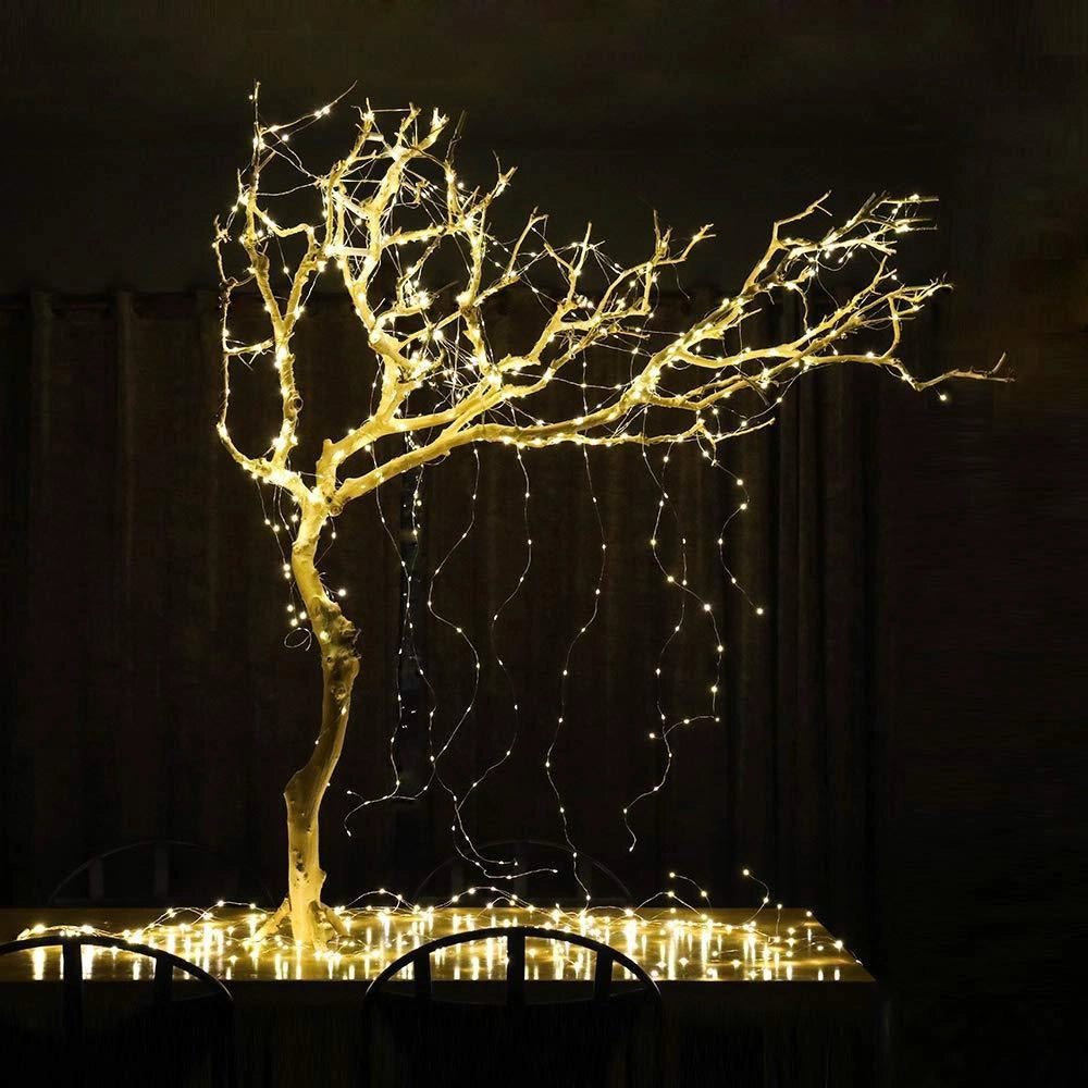 Solar powered outdoor LED fairy lights illuminating a tree branch at night, with a focus on their waterproof and eco-friendly features.