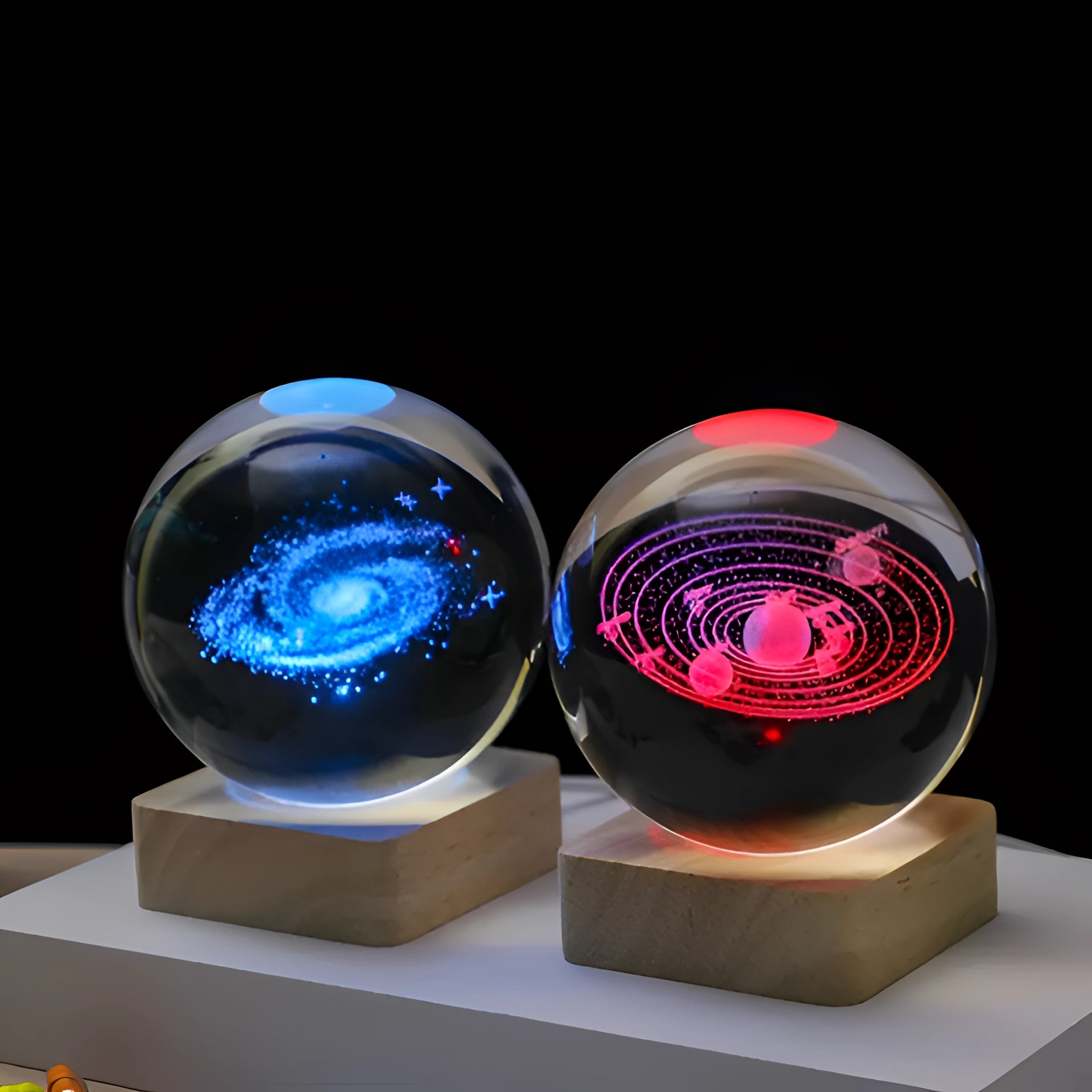 3D engraved solar system crystal ball on an LED base, featuring a vibrant display of galaxy design with electric blue lighting effects.