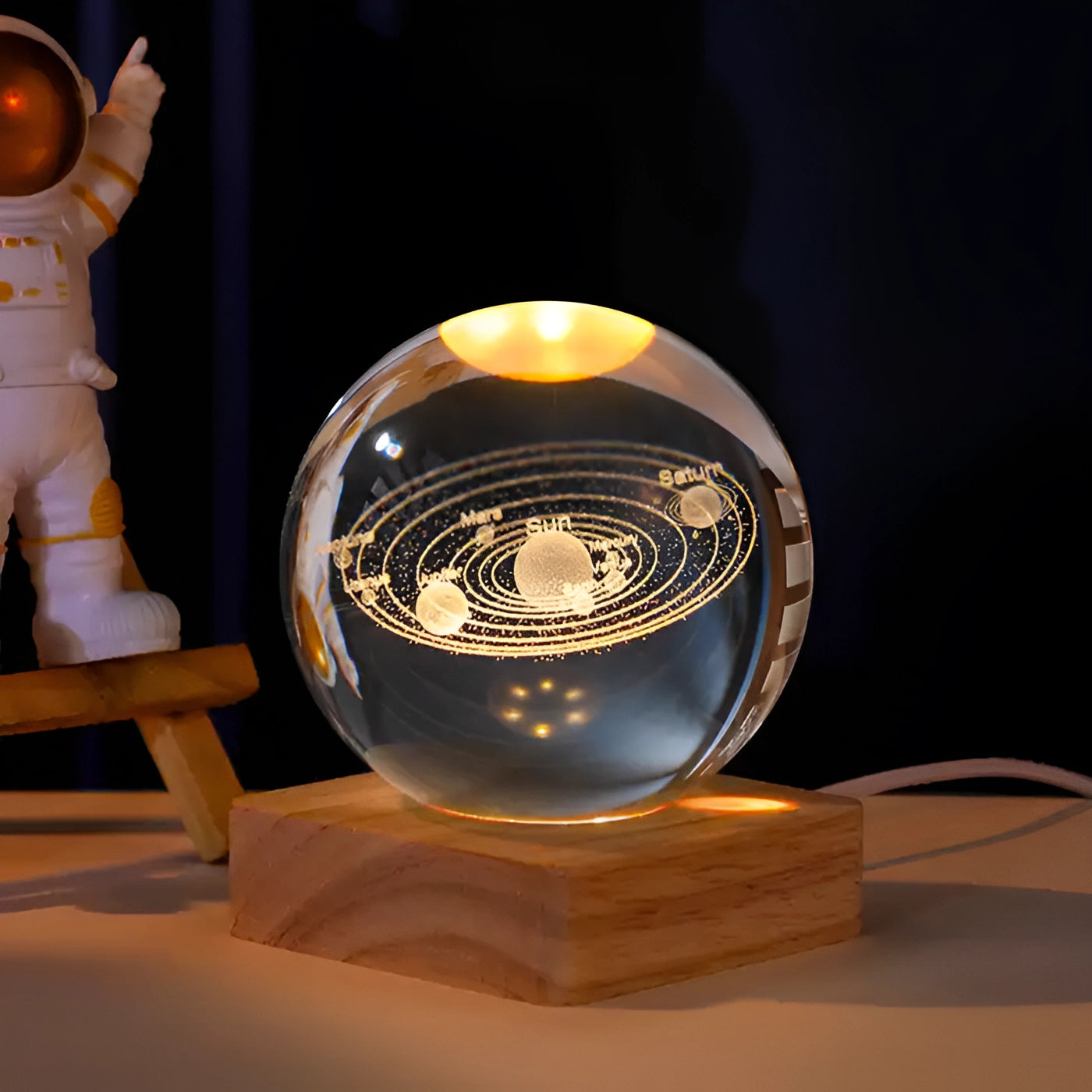 3D engraved crystal ball featuring the solar system, displayed on a LED base, resembling a futuristic art sculpture with a space theme.