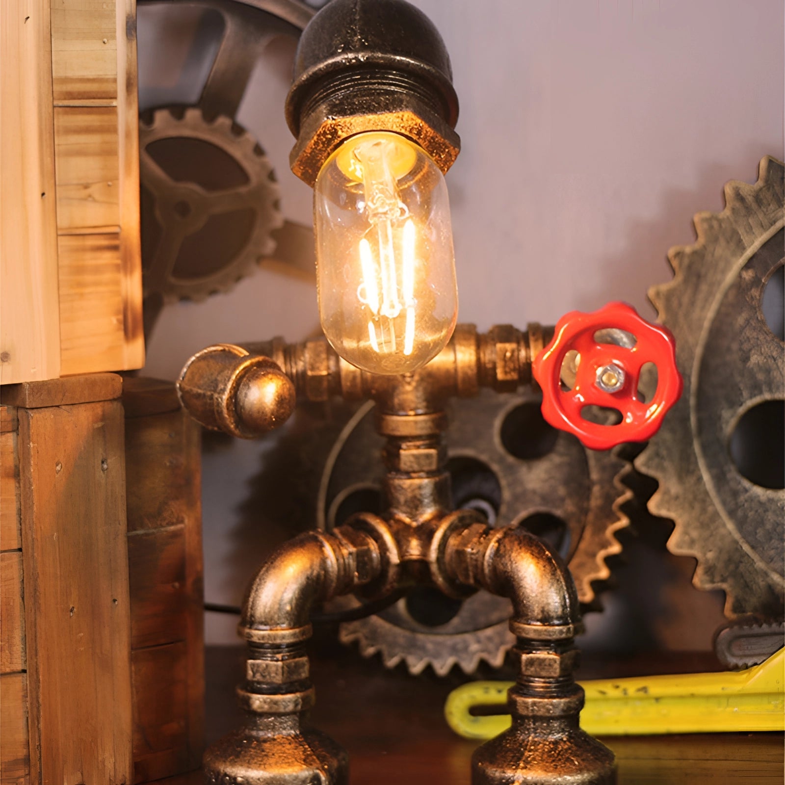 Steampunk industrial pipe table lamp with vintage gear decor, featuring an amber-tinted light and metal components, set on a wooden base.