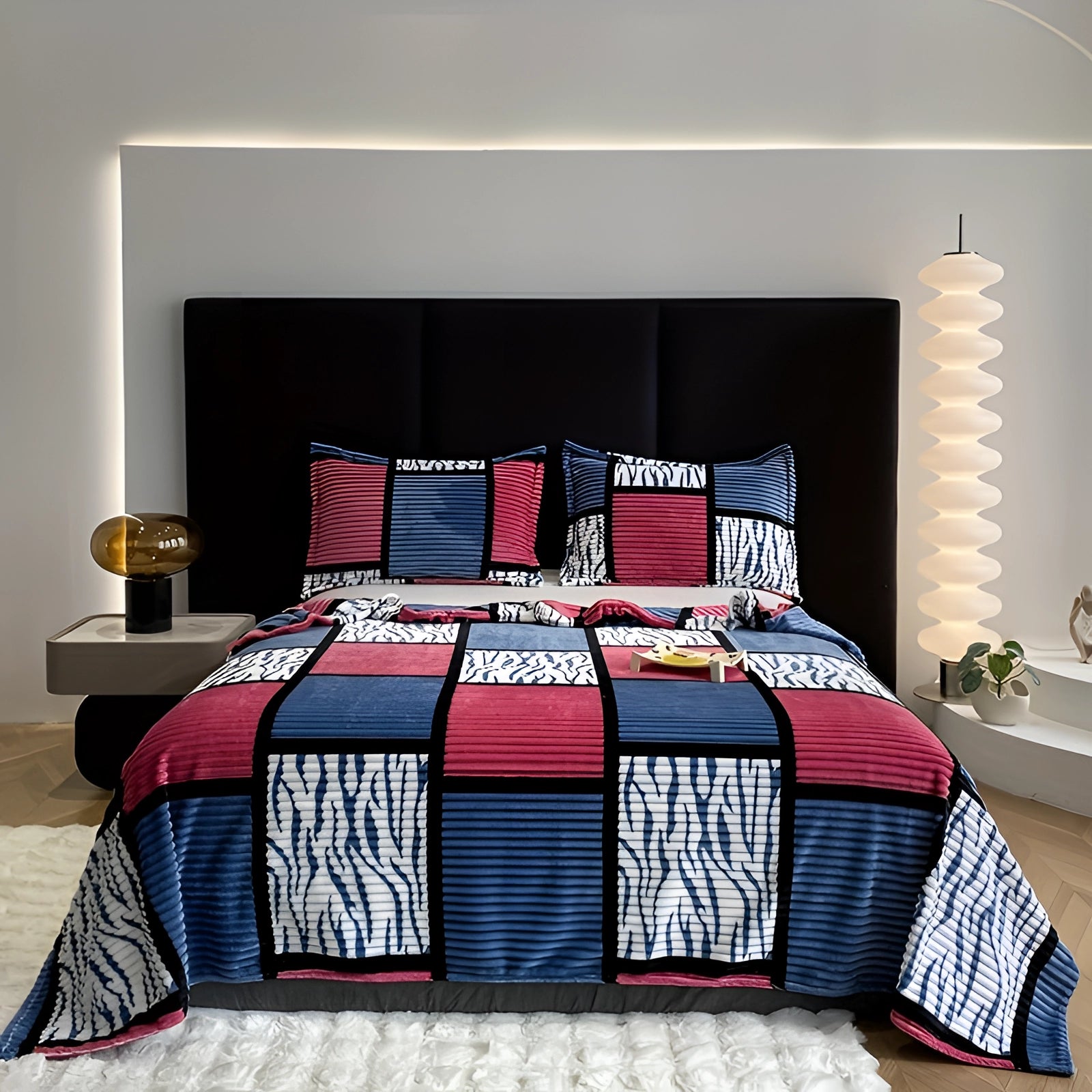 Striped bedding set in pink and blue geometric patterns displayed on a bed with matching pillows, in a contemporary interior setting with a wooden bed frame and a clean, modern floor space.