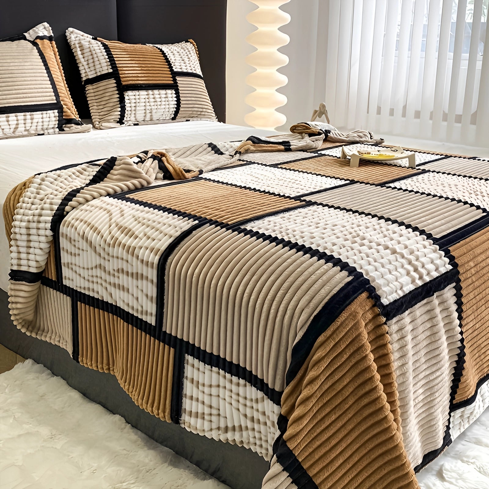 Striped bedding set featuring a modern geometric quilt on a neatly made bed with a wooden bed frame, complemented by pillows and surrounded by a stylish interior design.