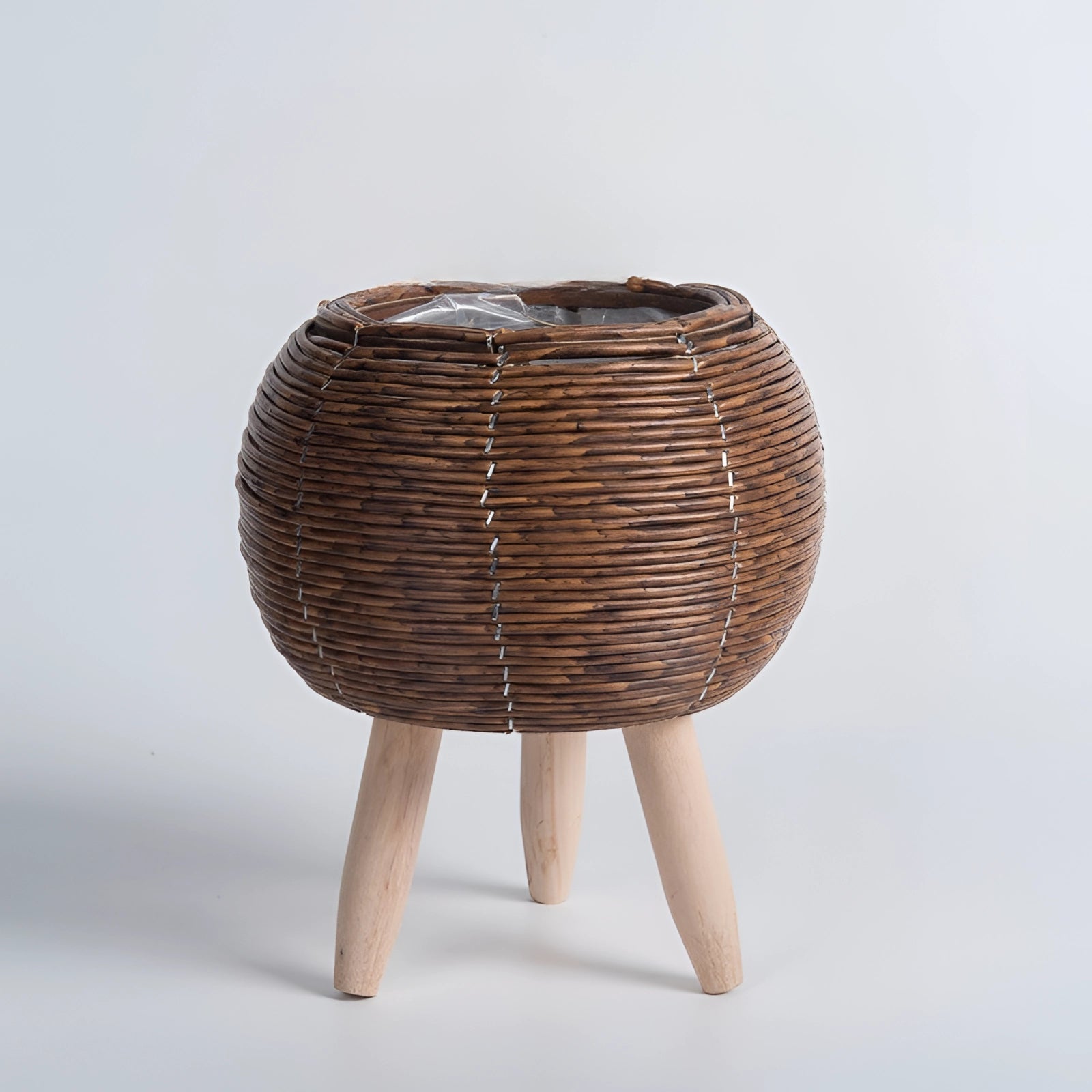 Stylish eco-friendly wicker planter with bamboo stand and legs featuring a rectangular shape and natural material finish.