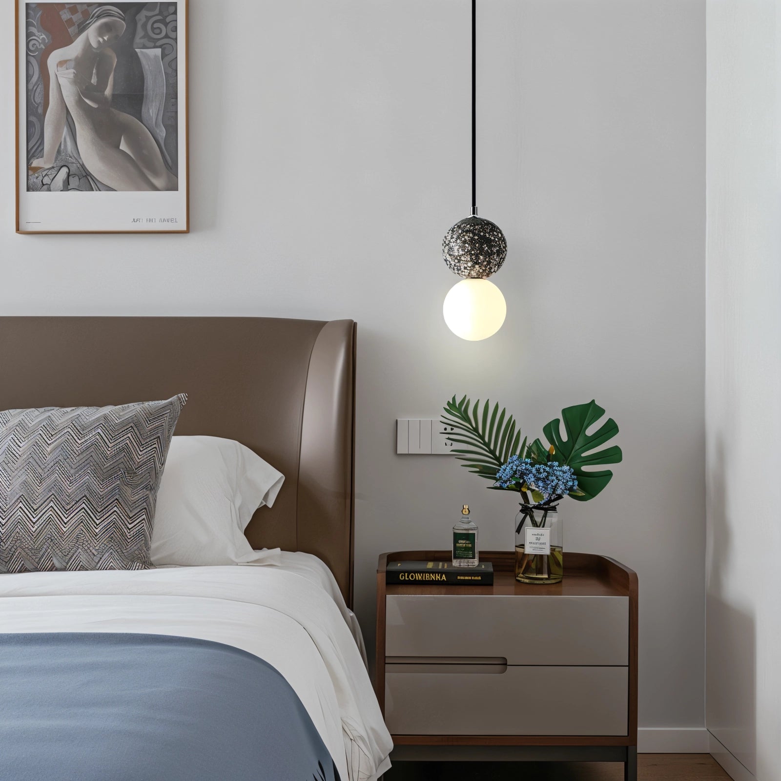 Terrazzo spherical pendant light with a minimalist concrete design, hanging in a modern interior setting, complemented by wooden elements and green plants for an inviting atmosphere.
