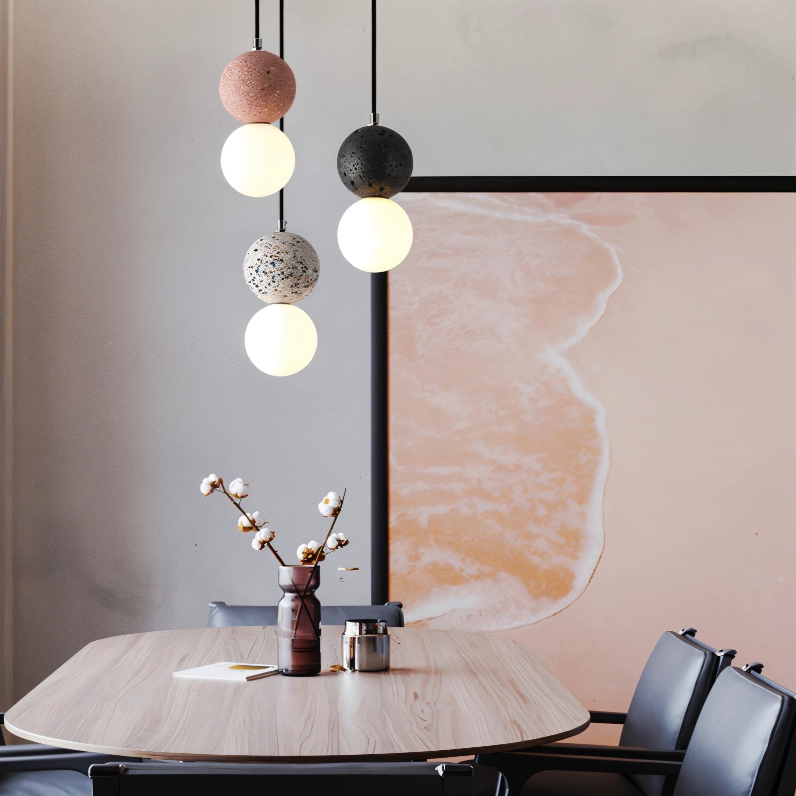 Spherical pendant light made of terrazzo with a minimalist design, hanging above a wooden table in a modern interior setting.
