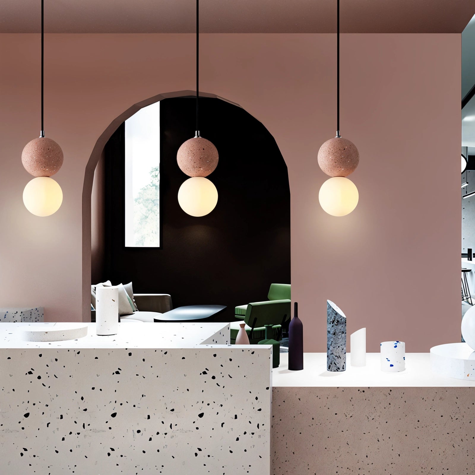 A minimalist terrazzo spherical pendant light crafted from concrete, hanging in a modern interior setting.