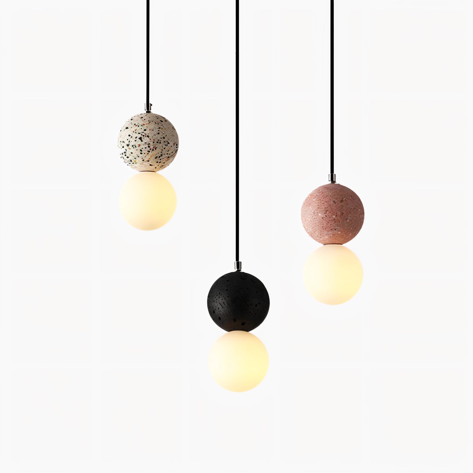 A minimalist spherical pendant light made of terrazzo concrete with a speckled pattern, suspended from the ceiling, designed as a modern ceiling fixture.