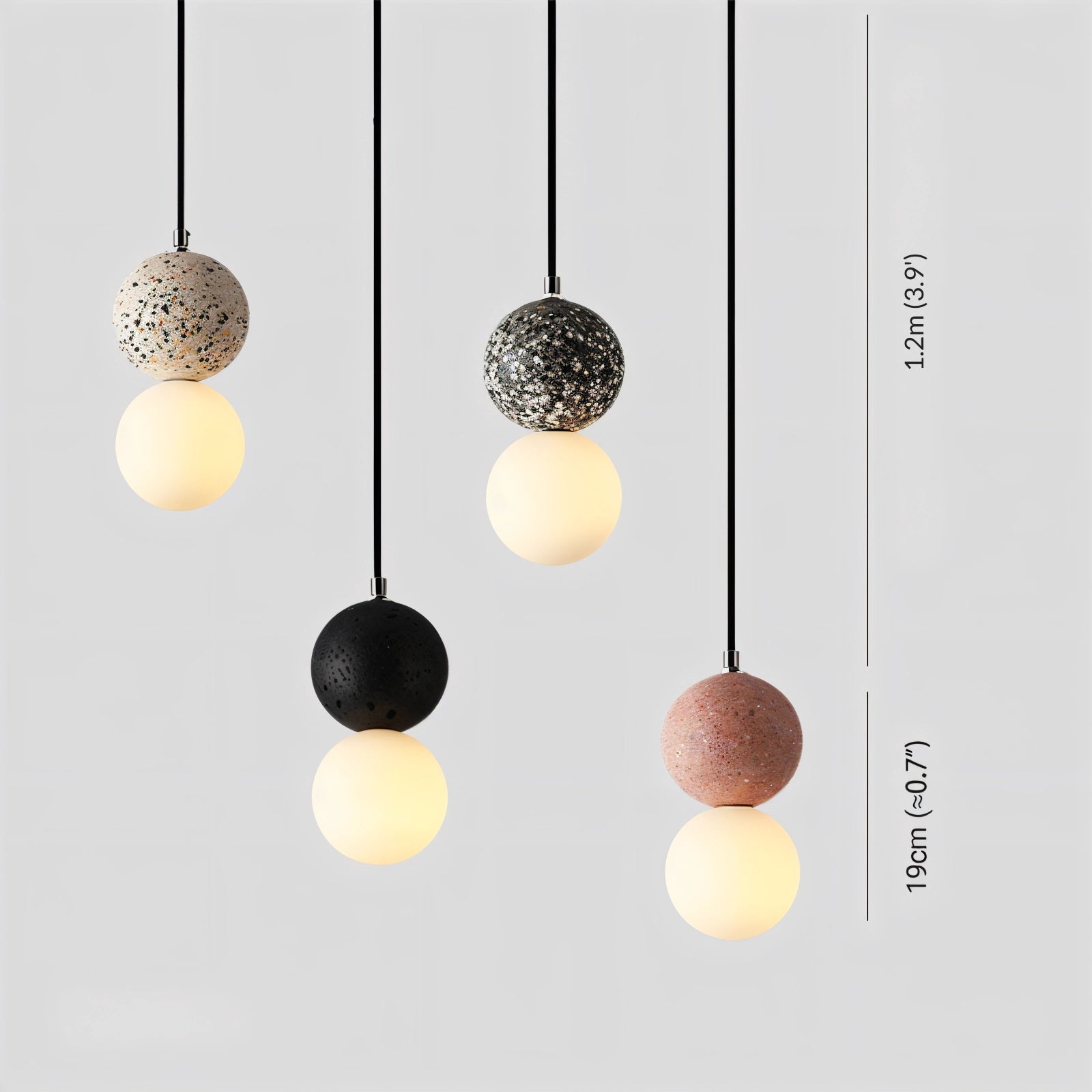 Spherical terrazzo pendant light fixture with a minimalist design, featuring a concrete material and subtle patterns. The fixture is suspended from the ceiling, showcasing a blend of art and function with a metallic accent.