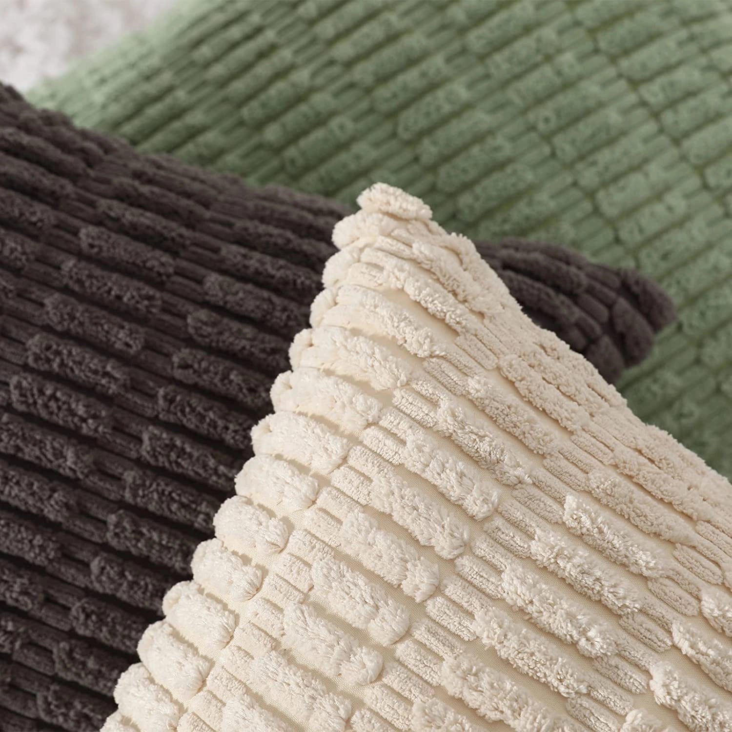 Textured beige corduroy cushions styled on a sofa with lumbar pillows, showcasing a cozy and elegant home decor arrangement.