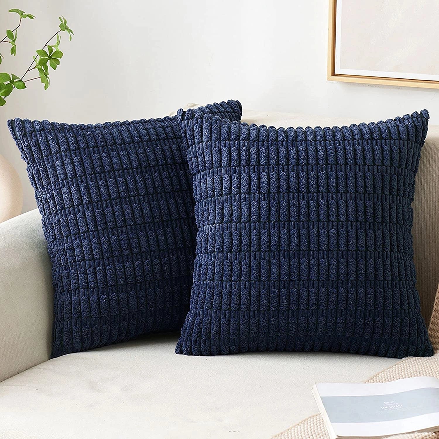 
A set of two marine-colored textured corduroy square cushions, measuring 45x45cm, placed on a beige sofa, showcasing a harmonious blend of comfort and interior design aesthetics.