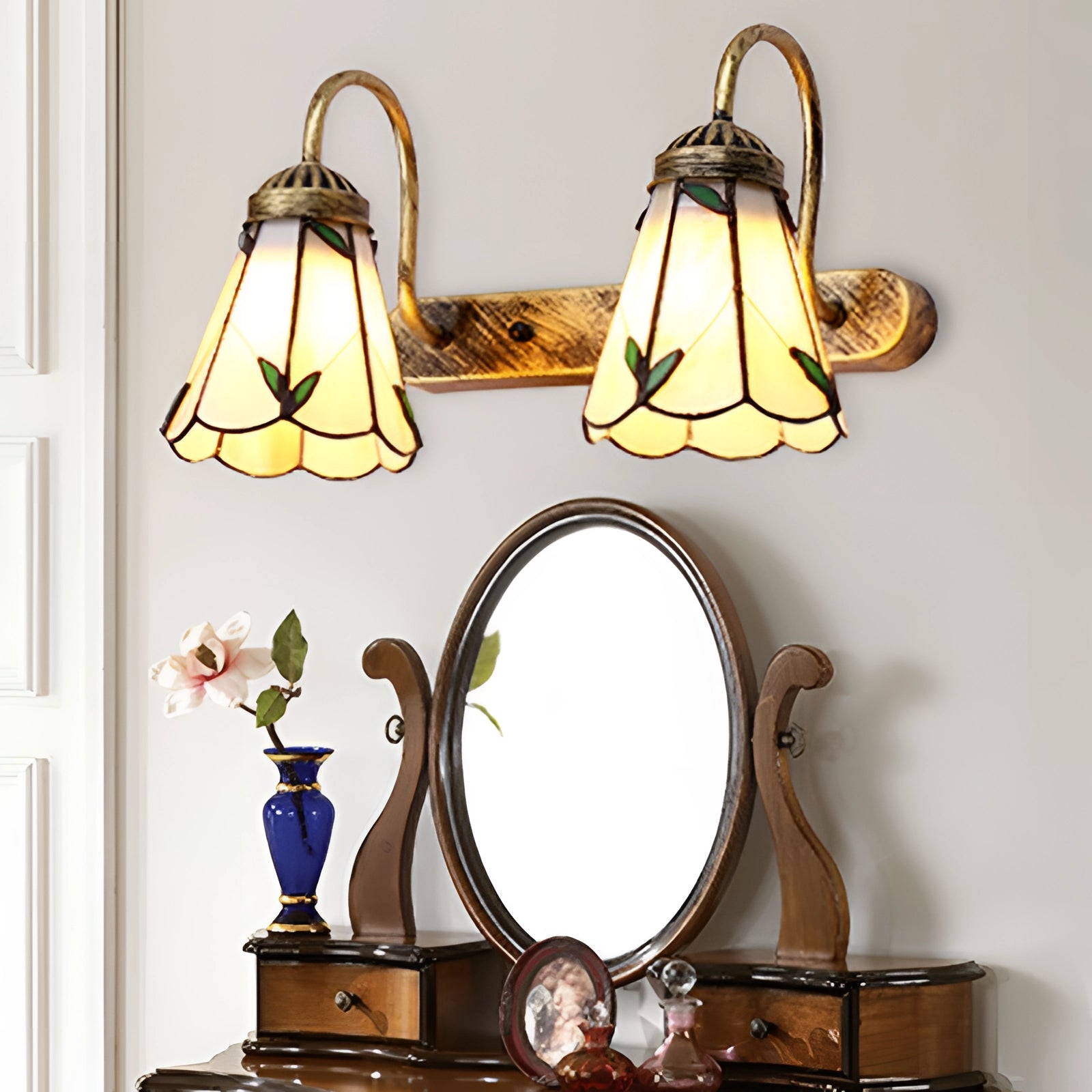 Tiffany stained glass floral wall sconce with dual lamp fixture featuring a decorative design in shades of brown and yellow, set against a white and metal background, ideal for interior design and room decor.