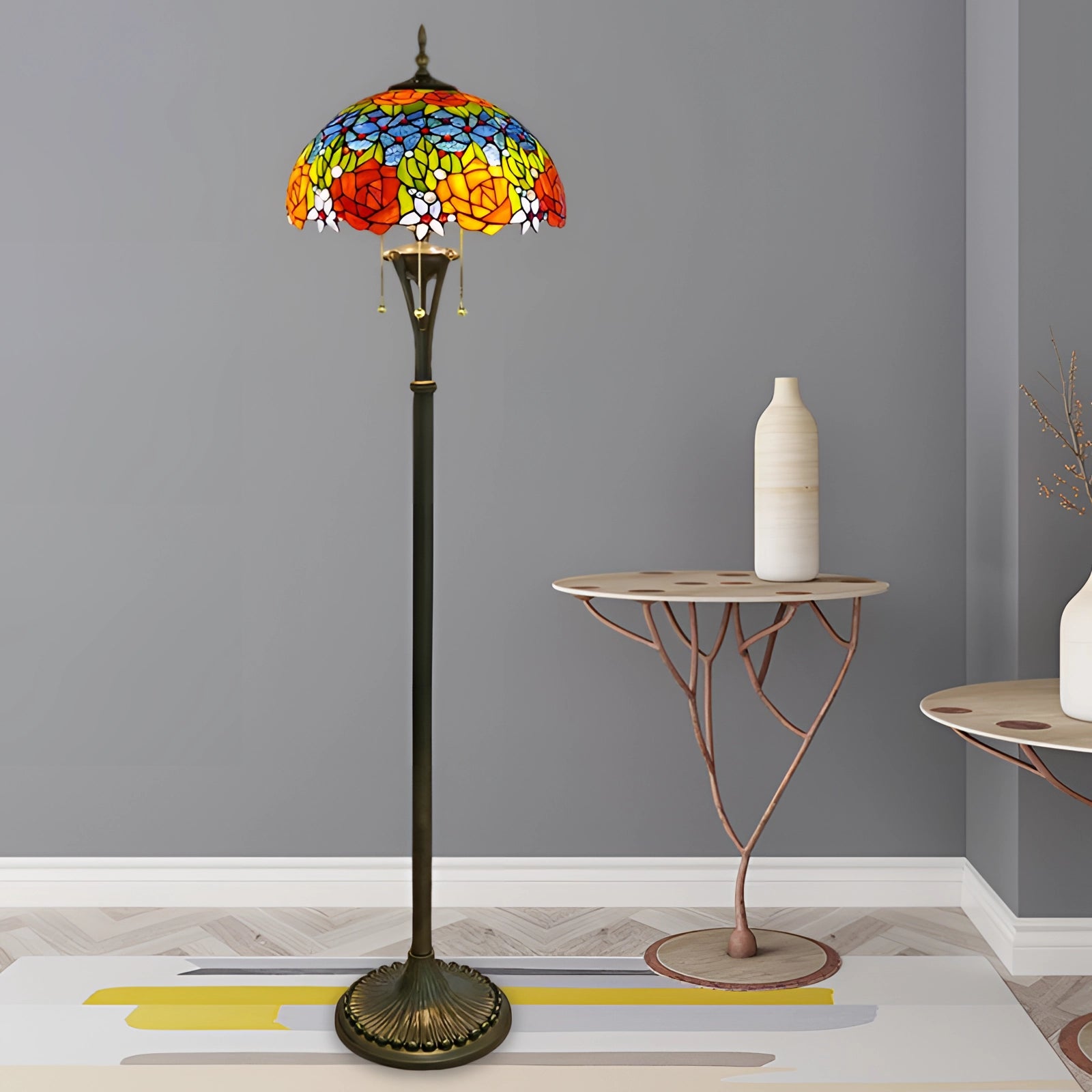 Tiffany-style floor lamp with a stained glass peacock feather design, featuring rich red and yellow hues, standing on a wooden base with intricate detailing, illuminating a warm white light.