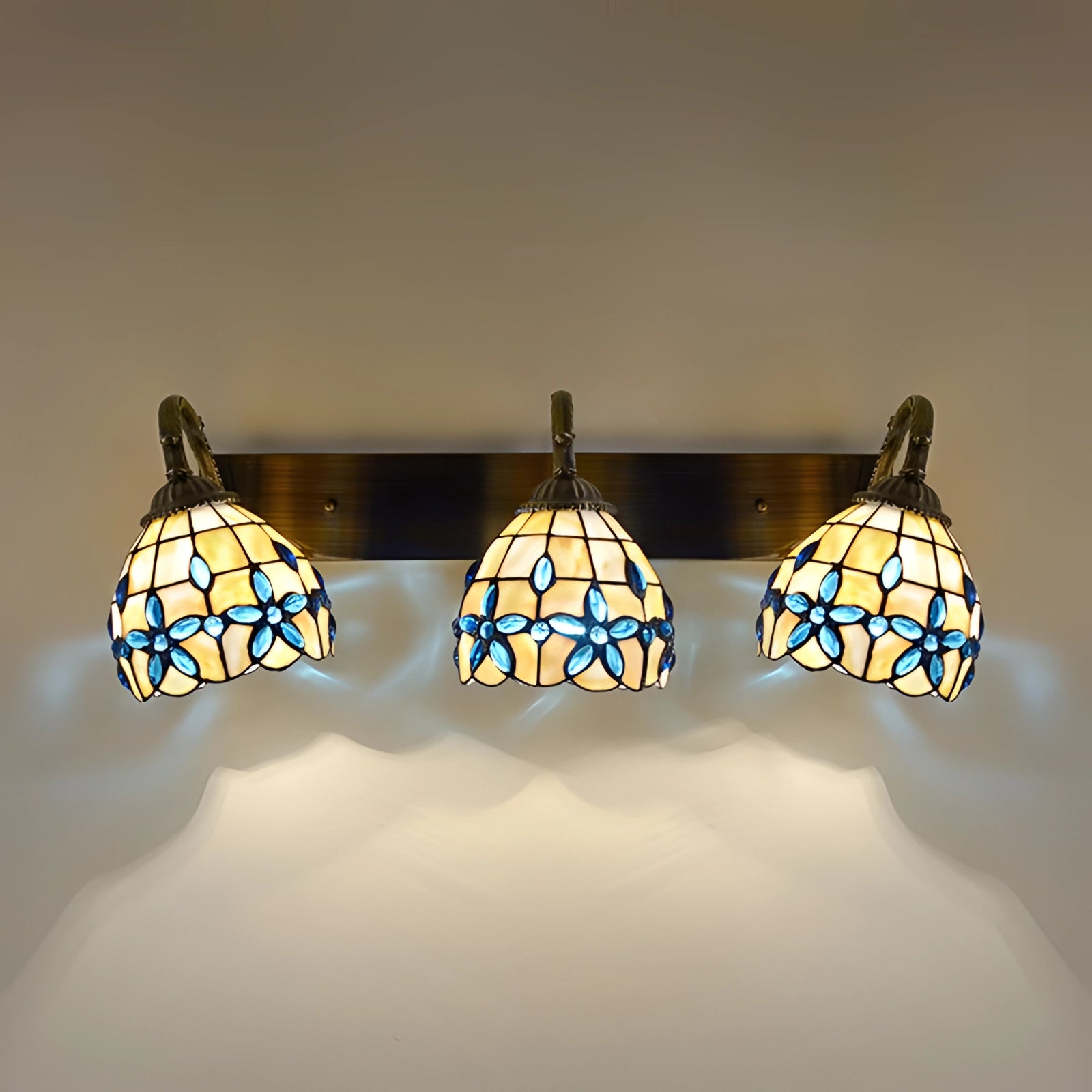 Tiffany-style vintage flower wall lamp with a stained glass design, featuring a 3-light fixture displaying intricate floral patterns and vibrant tints, ideal for artistic and ambient lighting.