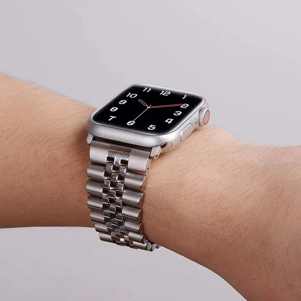 Tri-color stainless steel watch band in gold and silver, featuring an adjustable bracelet design.