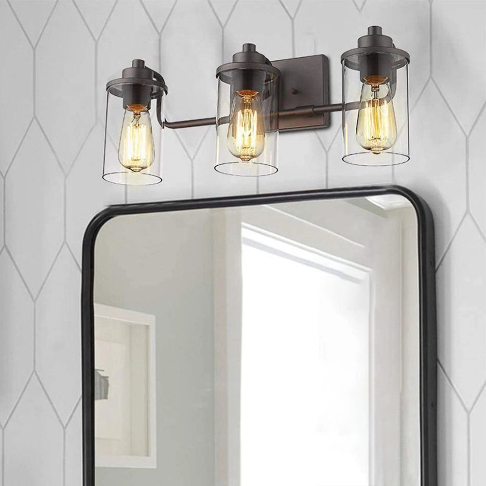 Triple lantern black metal frame 3-light sconce with clear glass shades, showcasing a modern rectangular design and featuring three visible light bulbs.