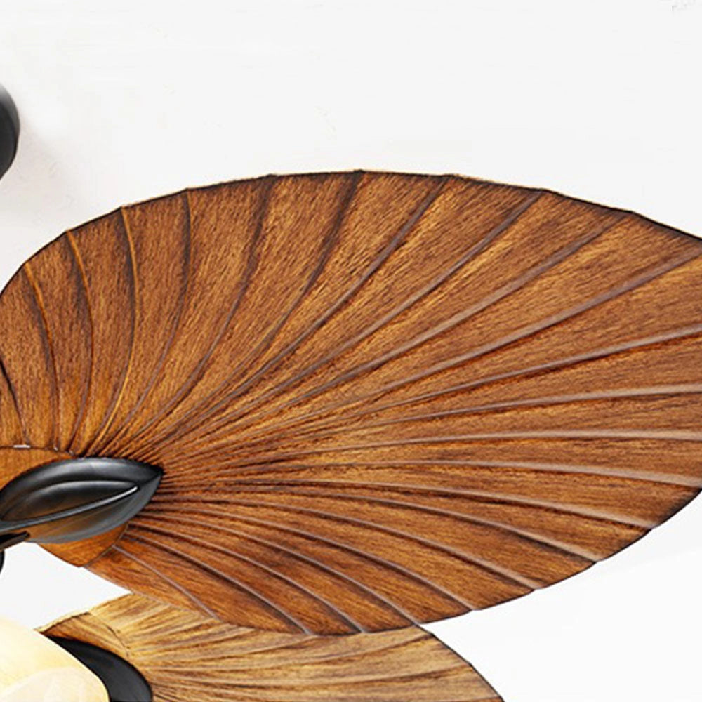 Tropical indoor ceiling fan with black finish and five palm leaf-shaped blades, showcasing wood-like texture and natural design elements.