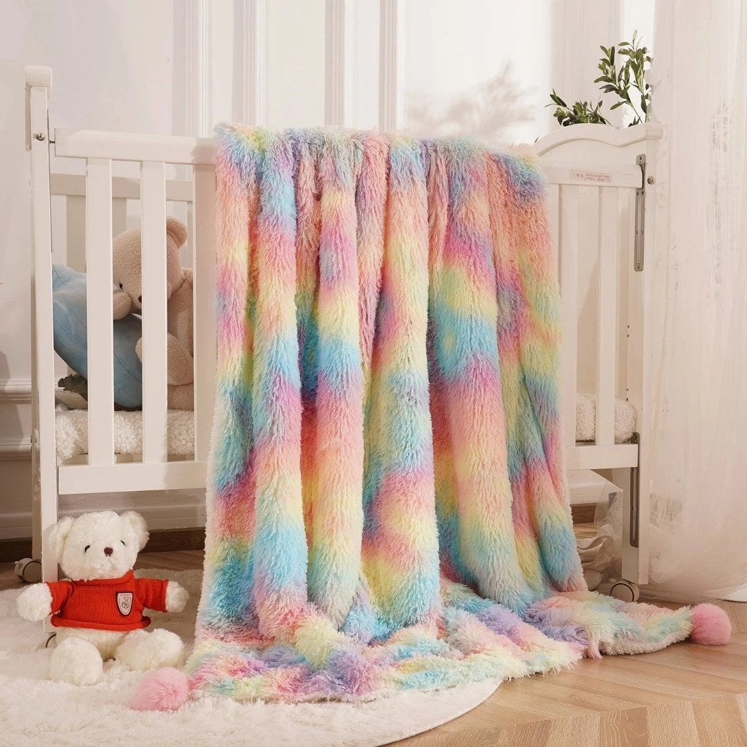 Soft pastel plush throw blanket in vibrant multicolor faux fur draped over a hardwood chair in a cozy living room setting.