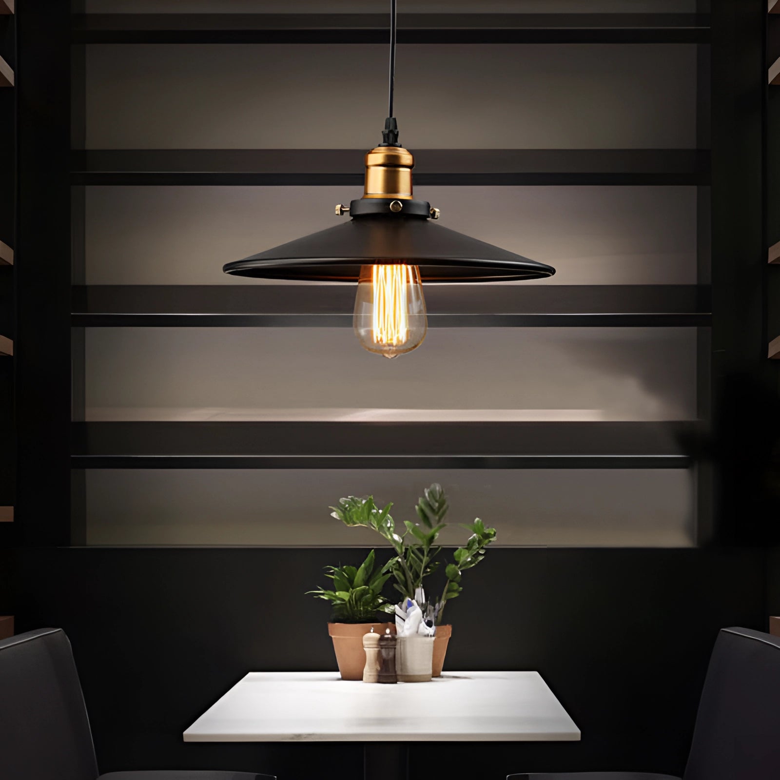 Vintage Black Edison Bulb Pendant Light with Industrial Metallic Dome hanging above a wooden table adorned with a green houseplant in a flowerpot.