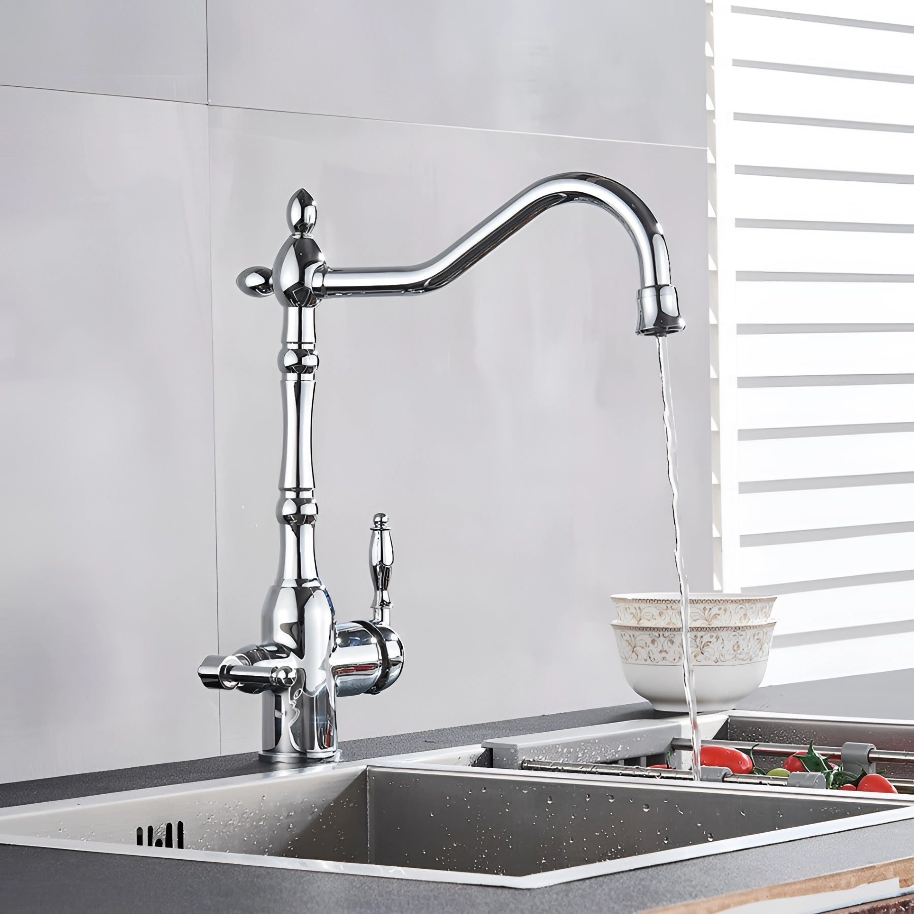 Vintage black gooseneck kitchen faucet with an antique design, installed on a grey countertop beside a sink.