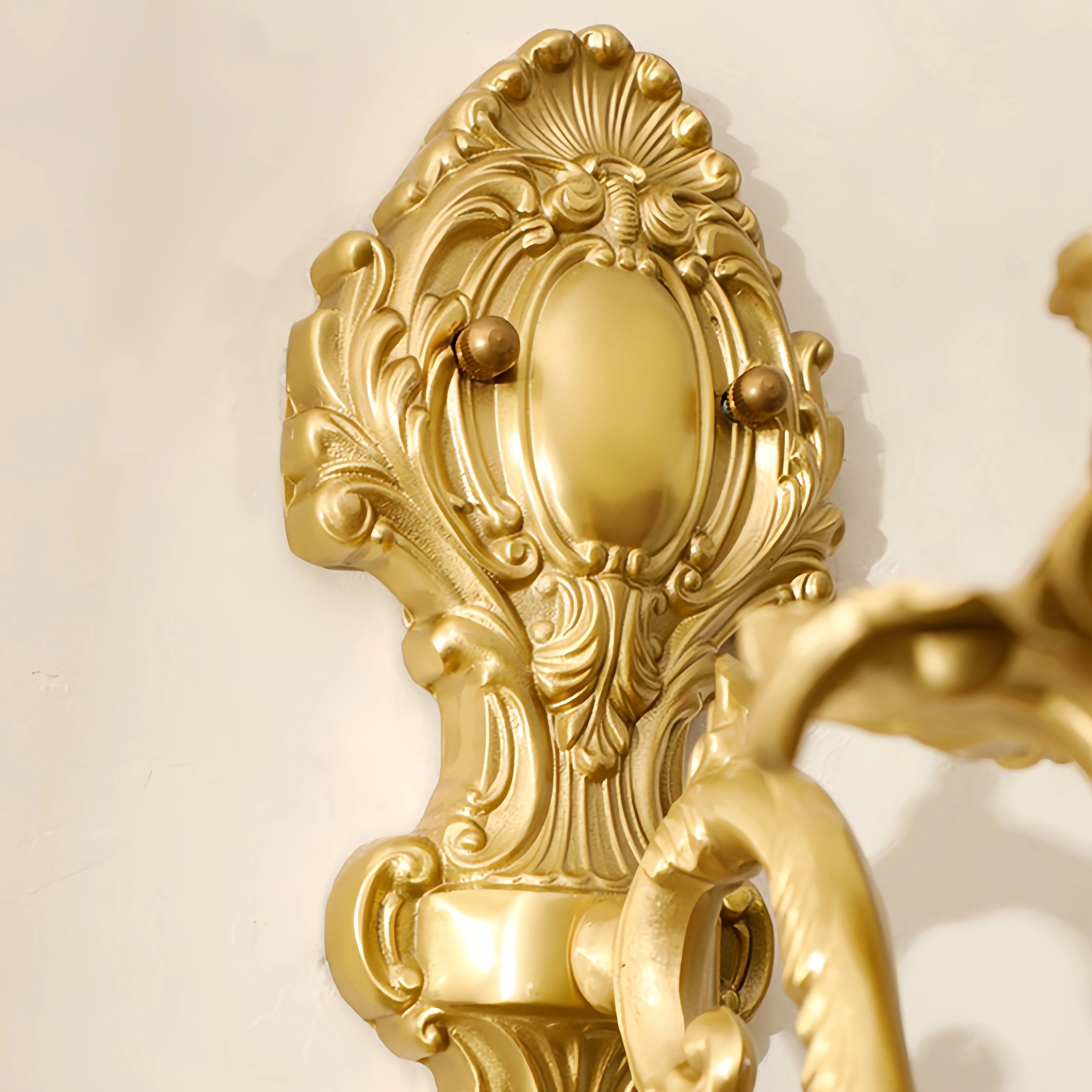 Vintage brass crystal wall sconce in an antique gold finish, featuring intricate metalwork with circular and patterned designs, resembling a sculptural art piece.
