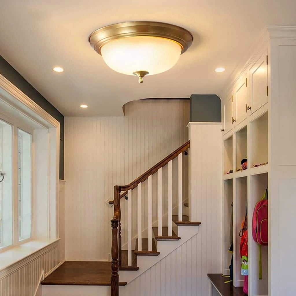 Vintage brass flush mount ceiling light with frosted glass shade, measuring 15 inches in diameter, installed in an interior setting.