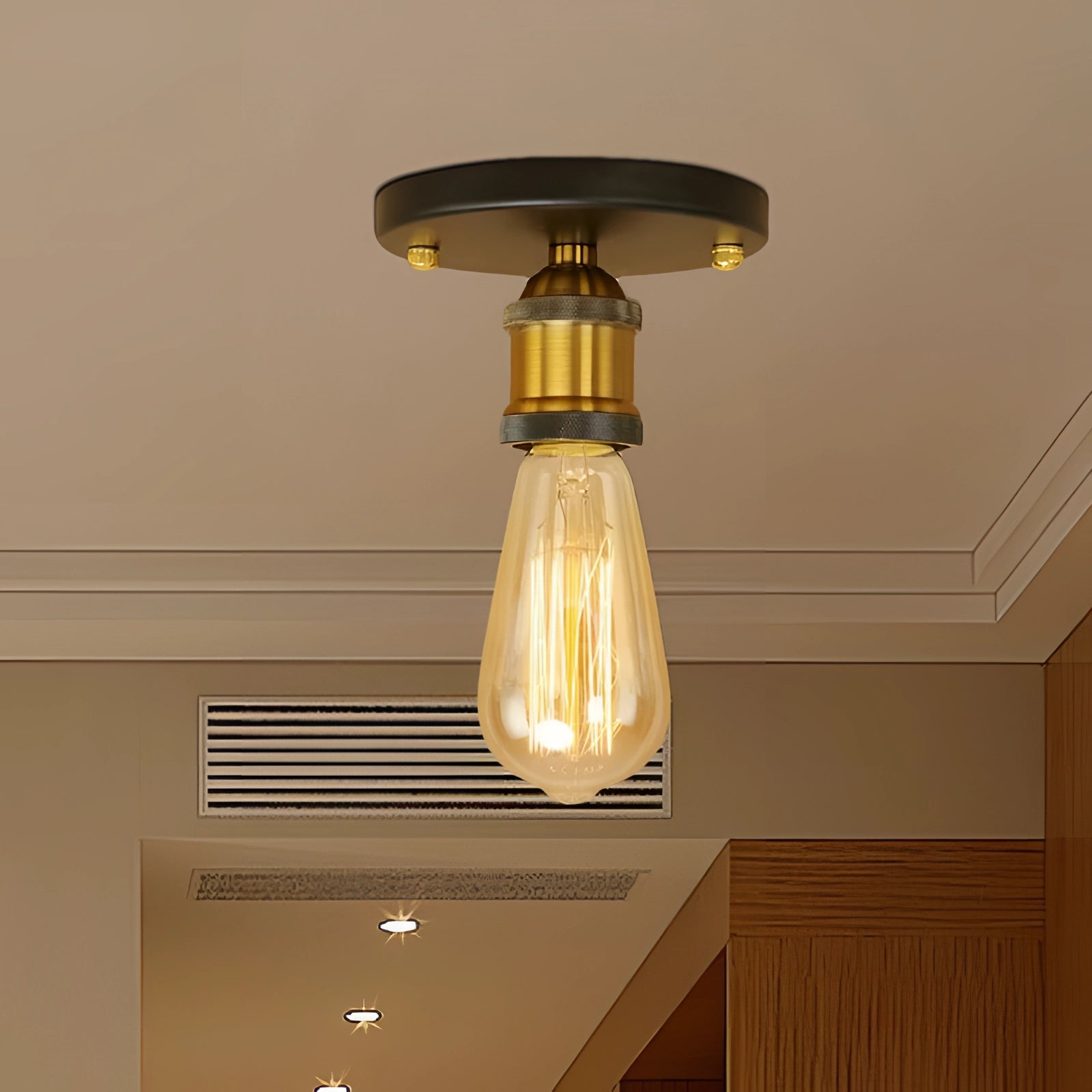 Vintage brass flush mount ceiling fixture with Edison bulb, featuring a retro industrial style design, mounted on a wooden ceiling with amber and metal accents.