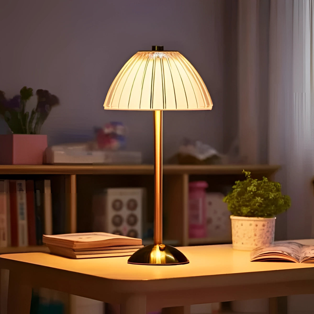 Vintage brass table lamp with pleated shade on a wooden table, surrounded by indoor plants and modern interior design elements.