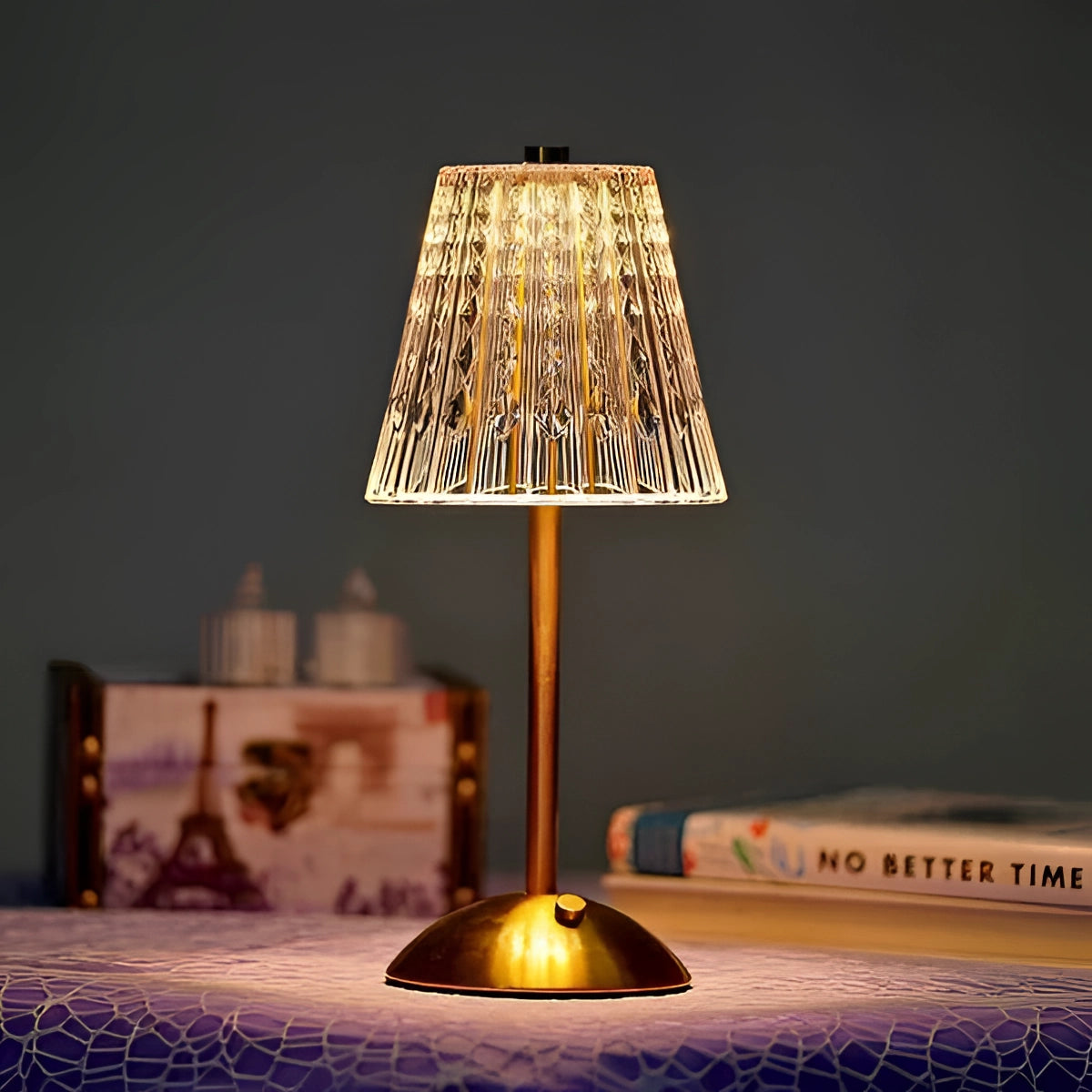 Vintage brass table lamp with a pleated shade, featuring a mid-century modern design. The lamp emits a warm yellow light contrasting with dark wood elements, showcasing its elegant material properties.
