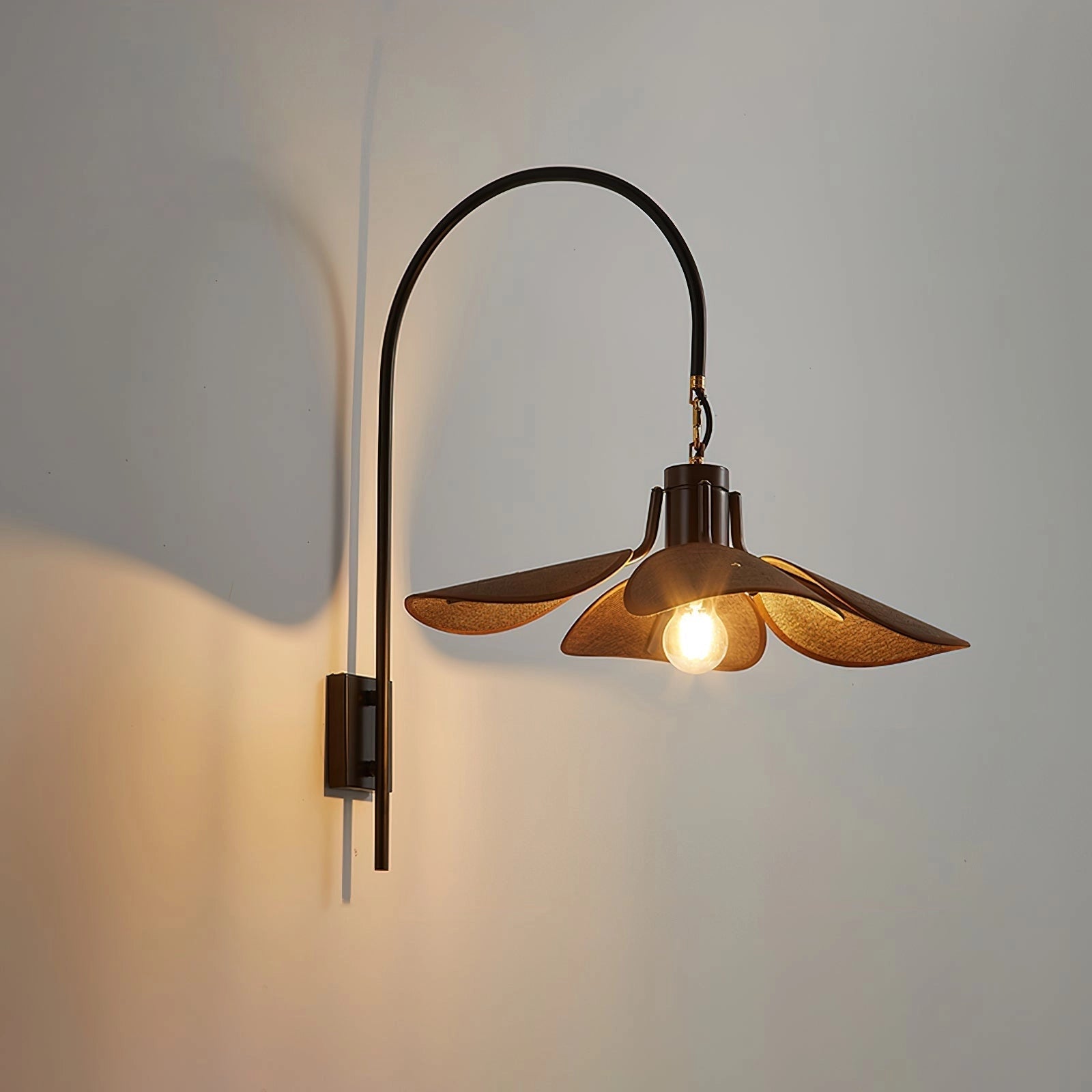 Vintage brass wall sconce with an adjustable dark brown wooden shade, featuring a warm amber glow and metal accents.