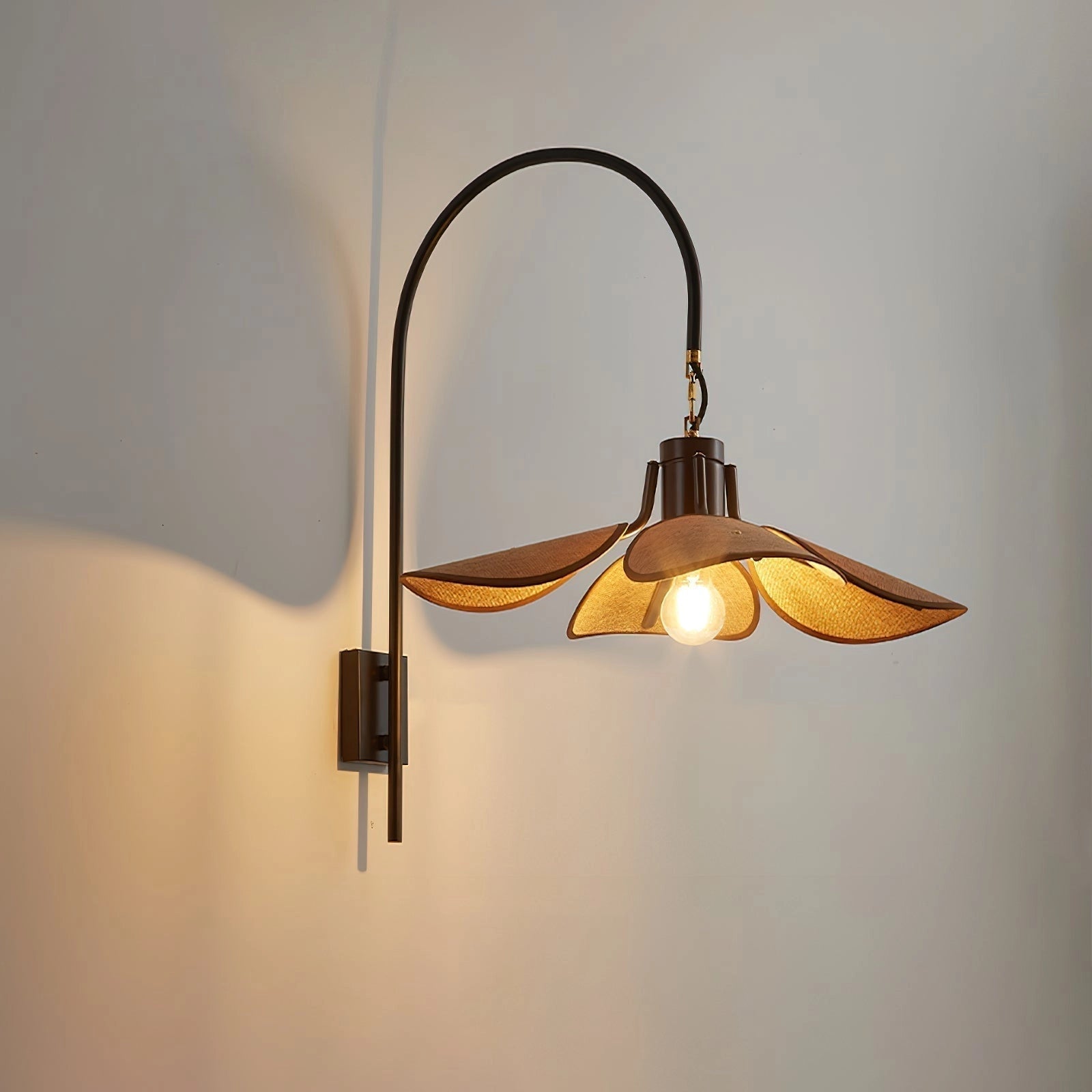 Vintage brass wall sconce with an adjustable light brown wooden shade, featuring a blend of metal and wood elements, designed for wall installation.