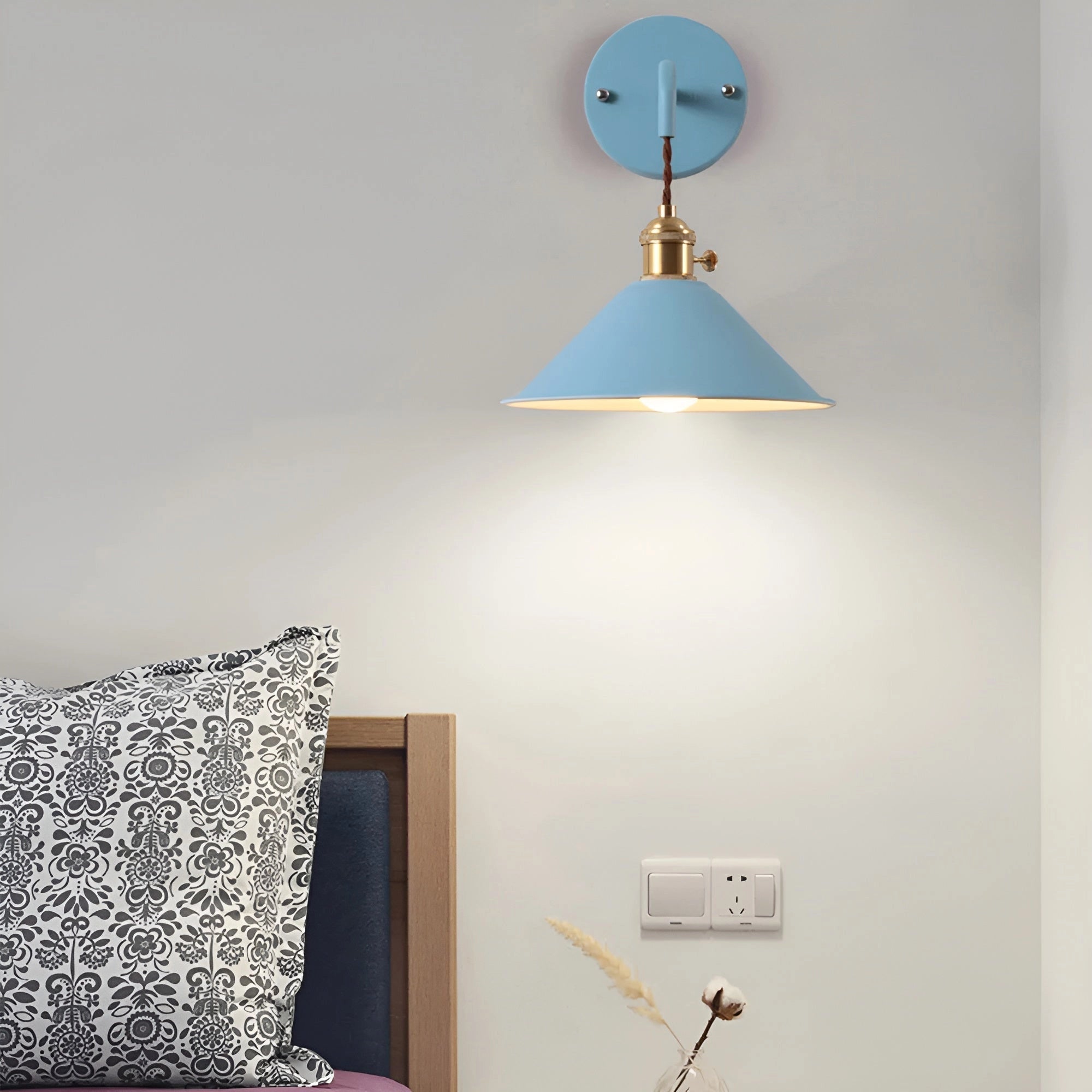 Vintage brass and white wall sconce with an industrial retro design, featuring a sleek brass frame, a white lamp shade, and mounted on a wooden wall.