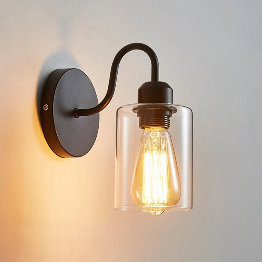 Vintage Edison Bulb Wall Sconce in black metal with clear glass, featuring a decorative light bulb design, suitable for adding a rustic charm to interiors.